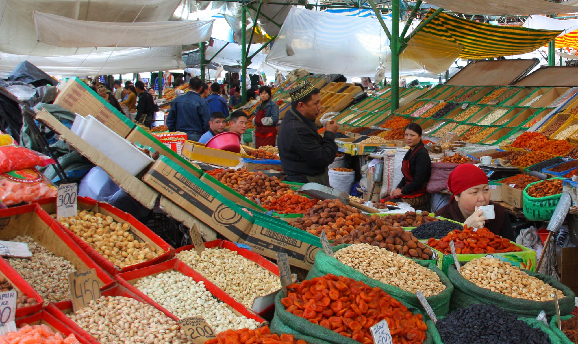 A market stall piled with dried fruits and nuts