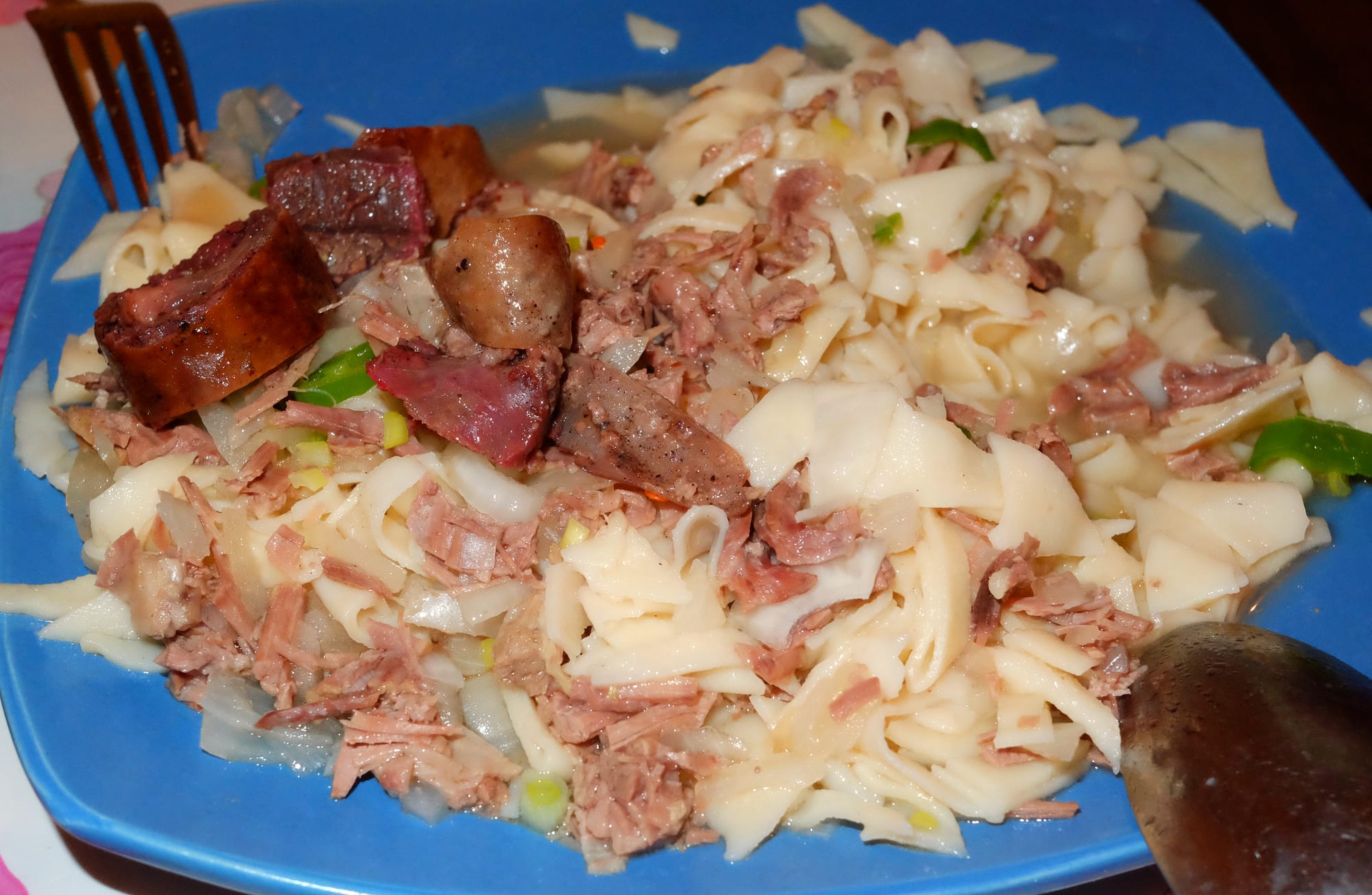 Boiled meat and hand-cut noodles on a large platter