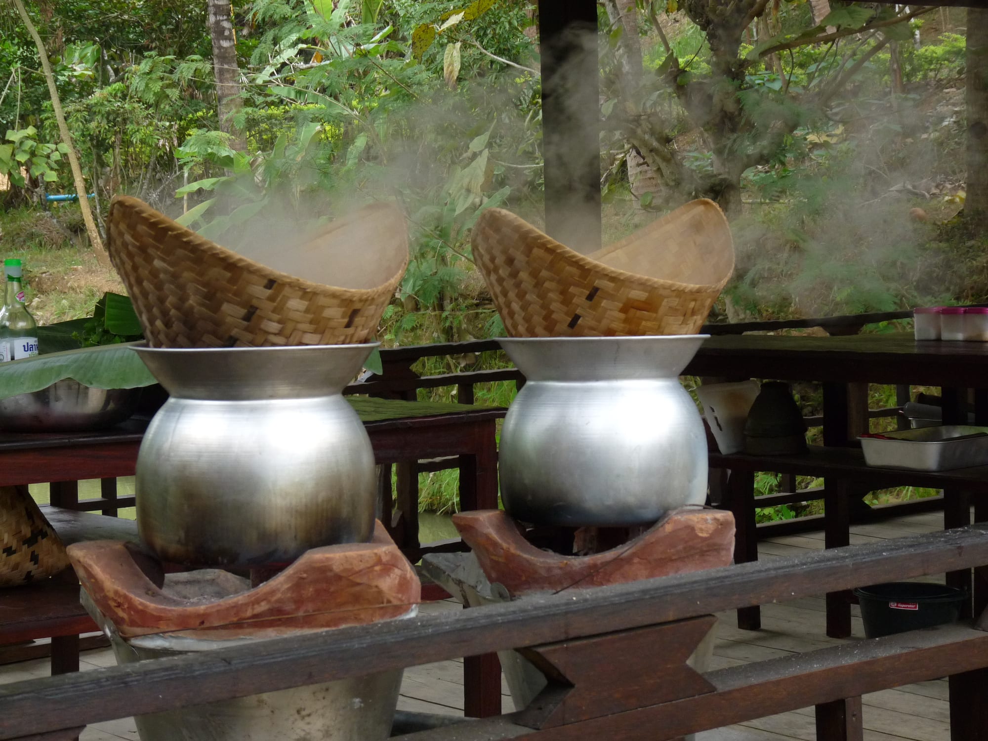Woven conical baskets used to steam rice over pots