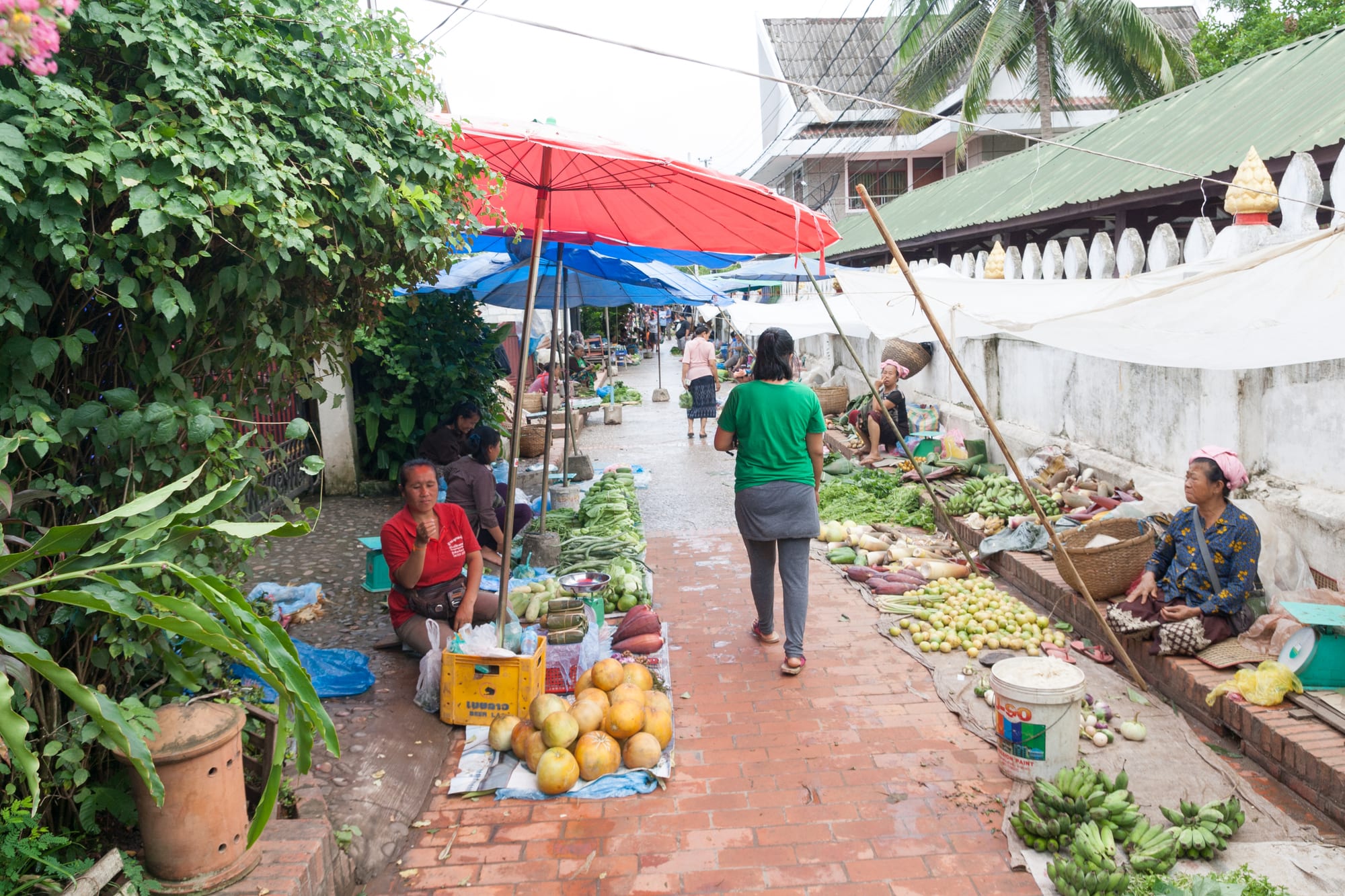 A busy morning market with vendors selling fresh produce