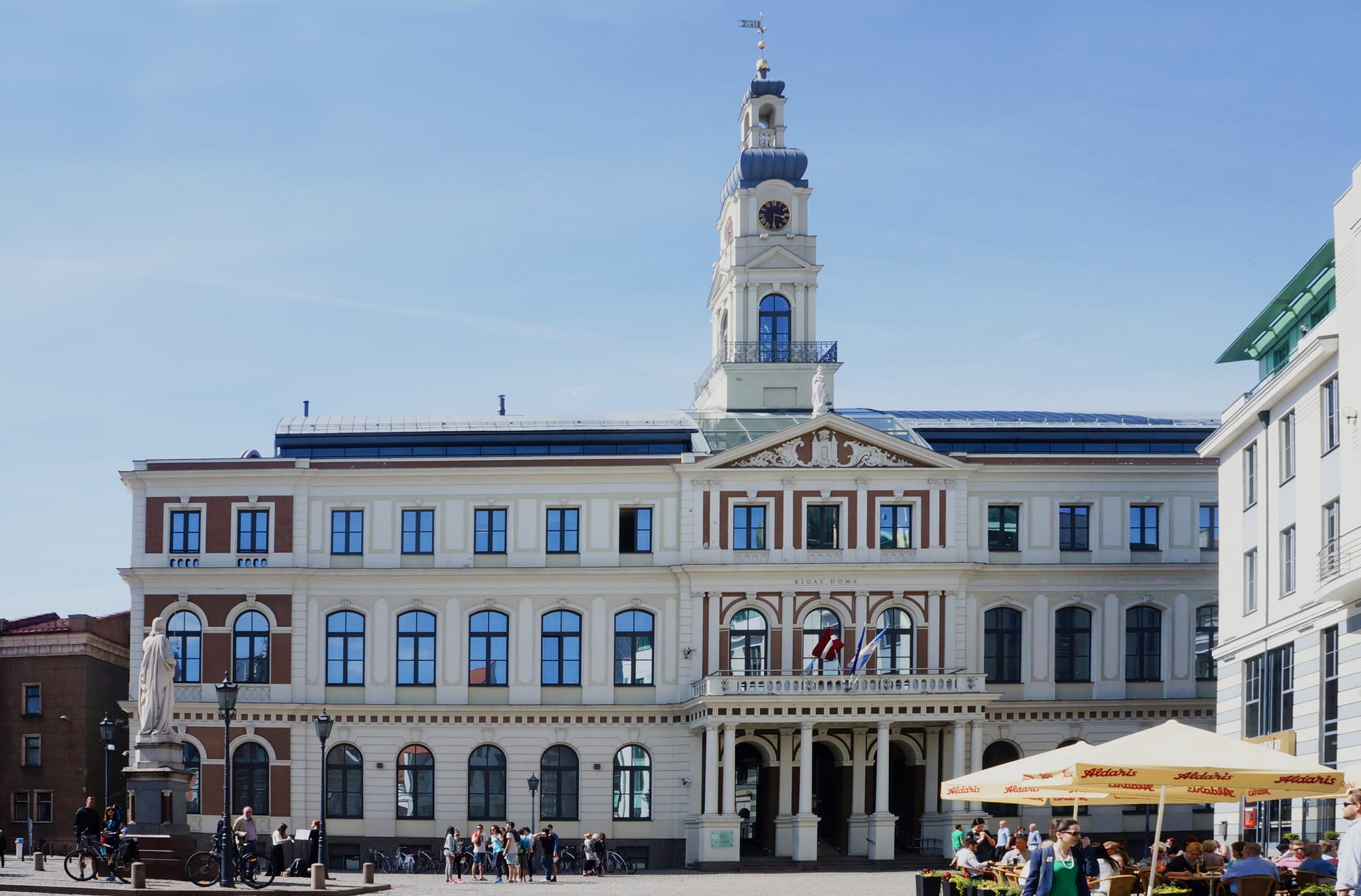 A reconstructed Gothic-Renaissance town hall with stepped gables on a cobbled square
