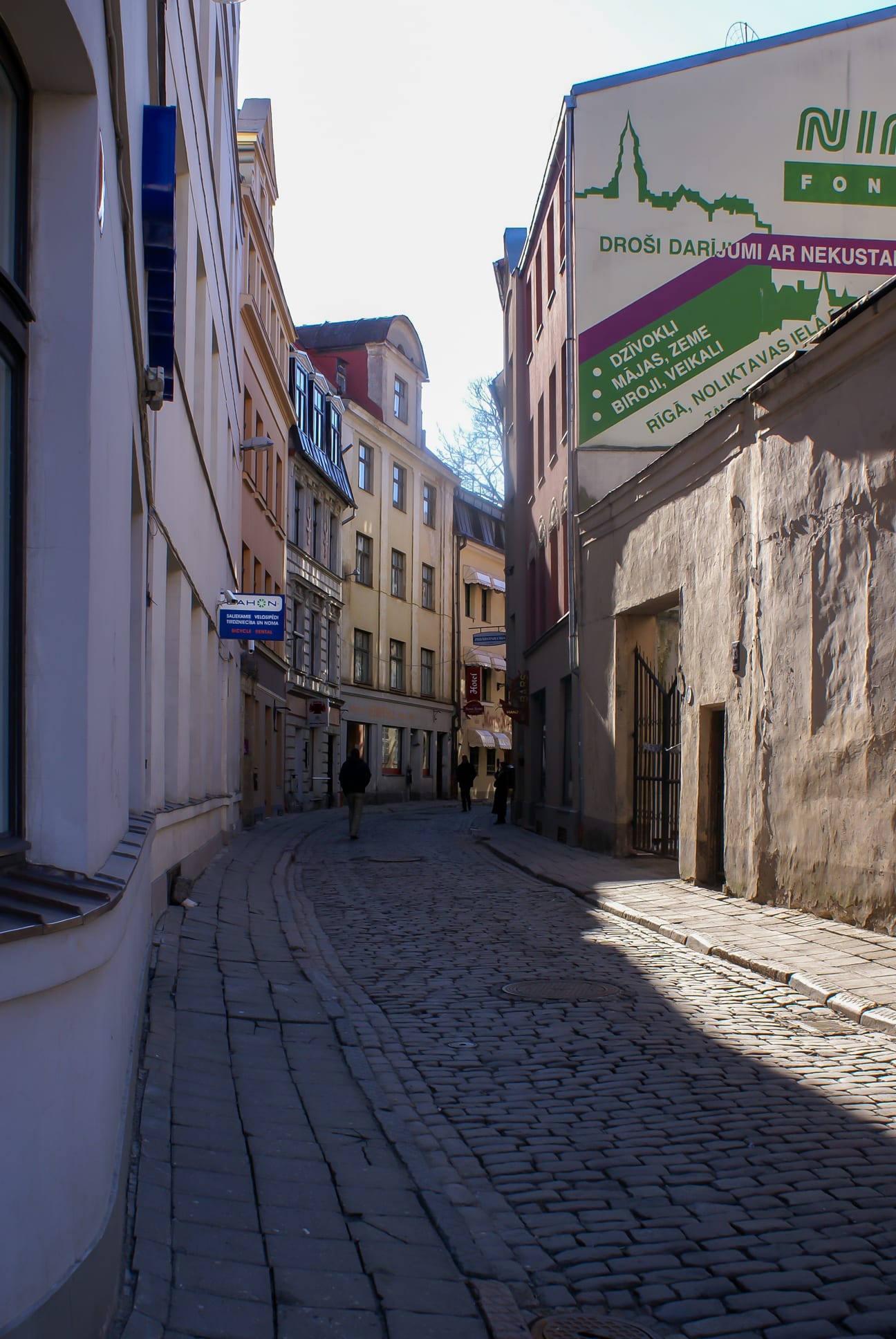 A dense cluster of medieval gabled townhouses and church spires above a cobbled square