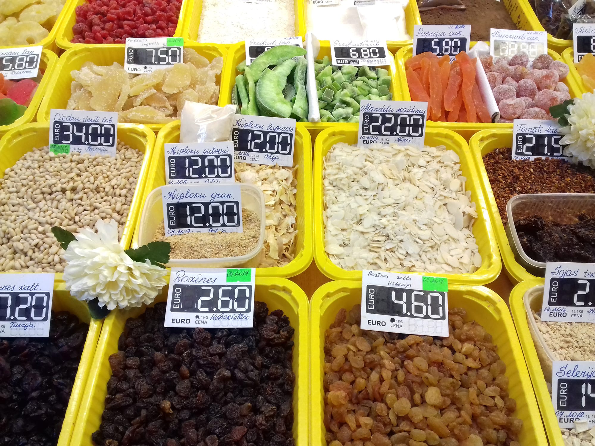A market stall with bowls of dried fruit