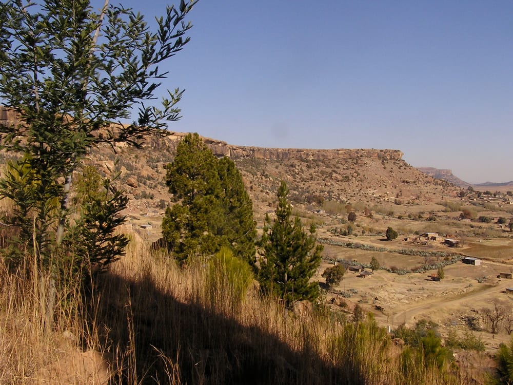 A flat-topped sandstone mountain rising above surrounding grassland