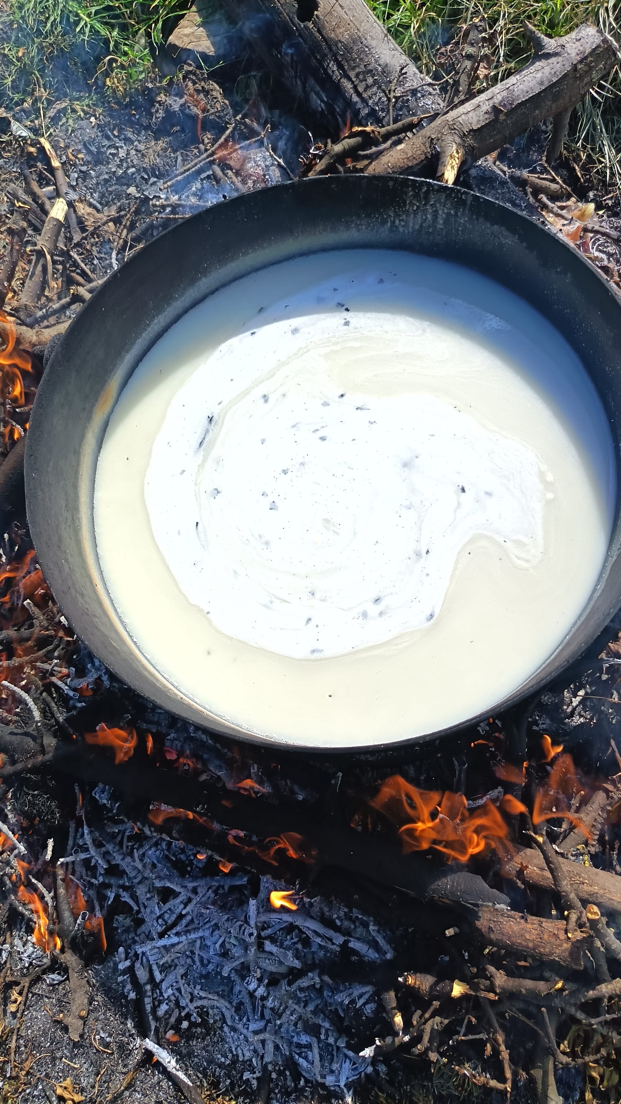 Fermented maize meal being cooked over an open fire