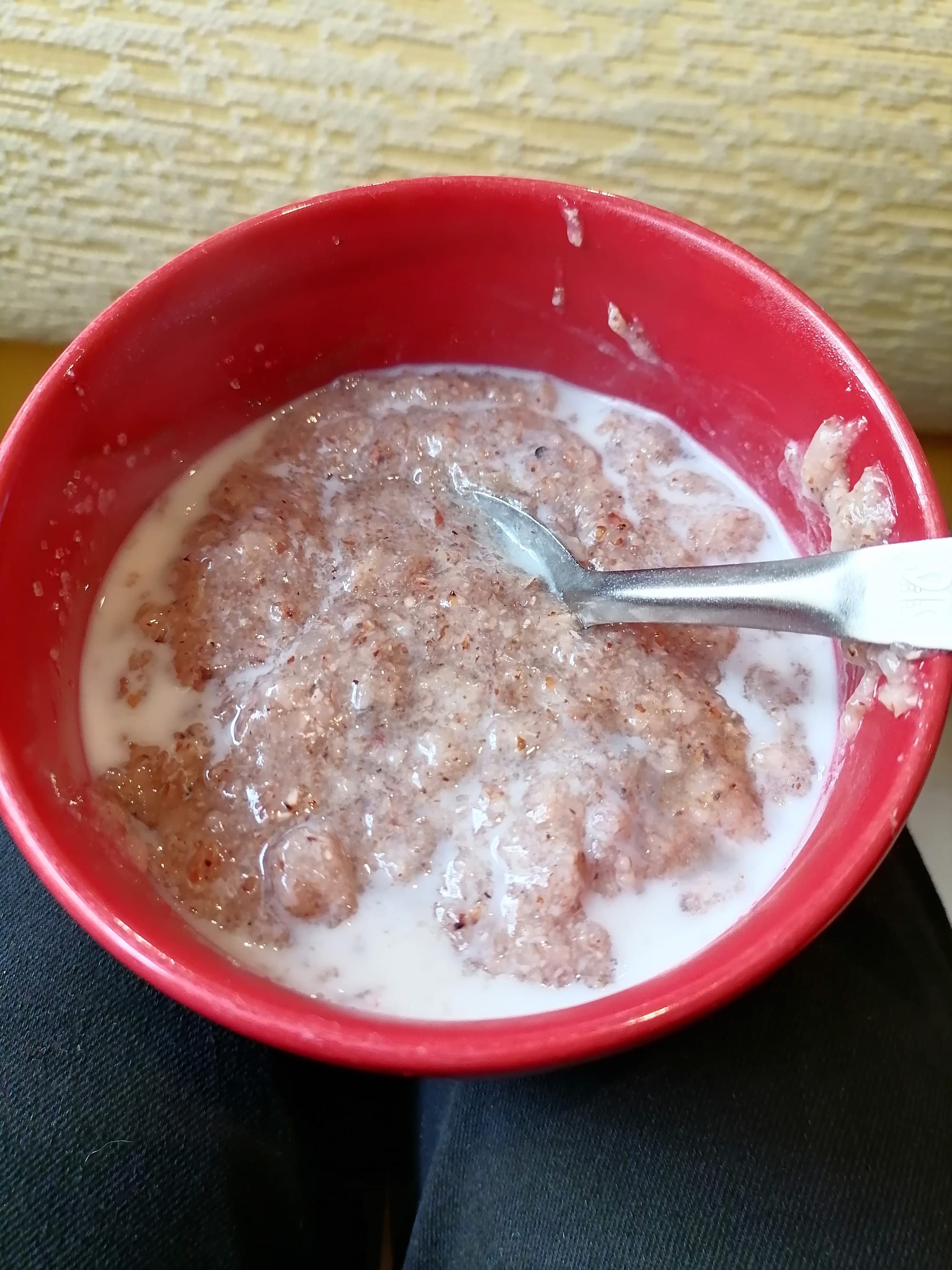 A bowl of pale, thin porridge made from sorghum and milk