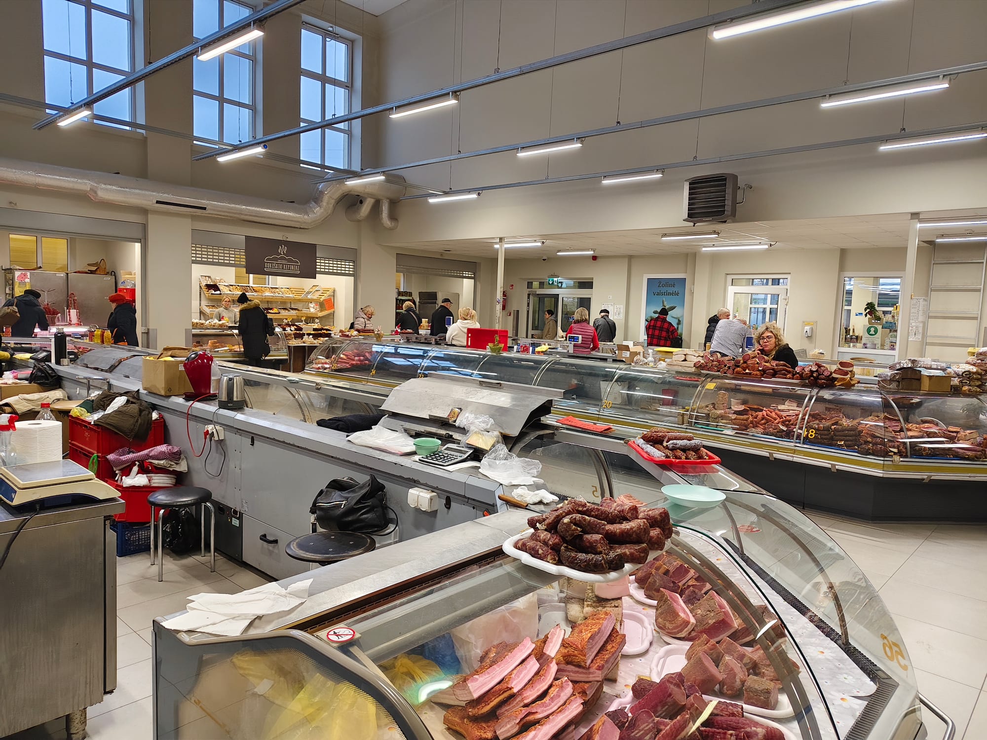 The interior of a covered market hall with vendor stalls