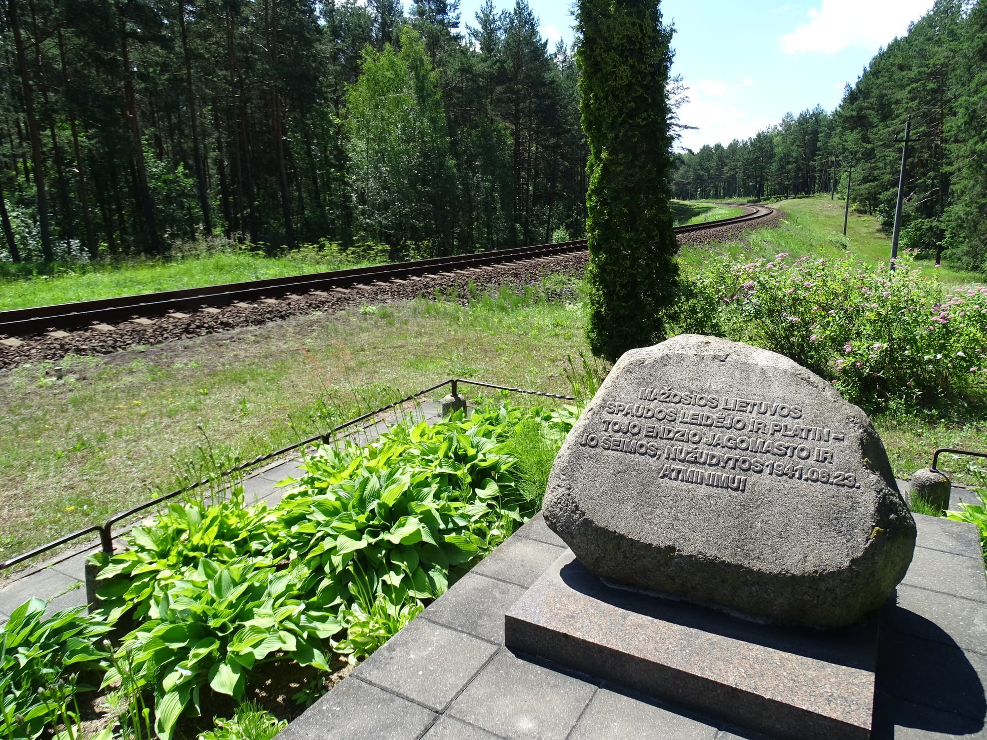 A stone memorial in a forest clearing at Paneriai, where mass shootings took place