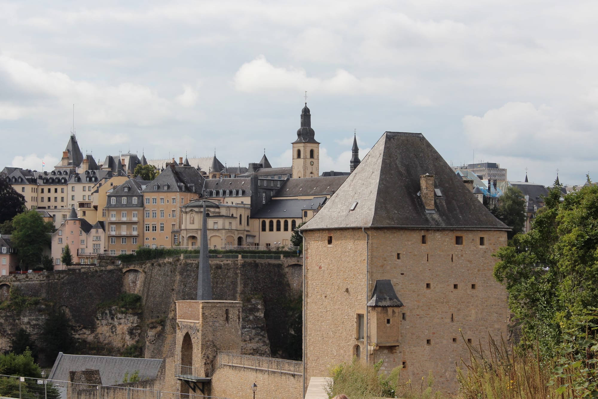 A city of fortress walls and church spires perched above a deep green river gorge