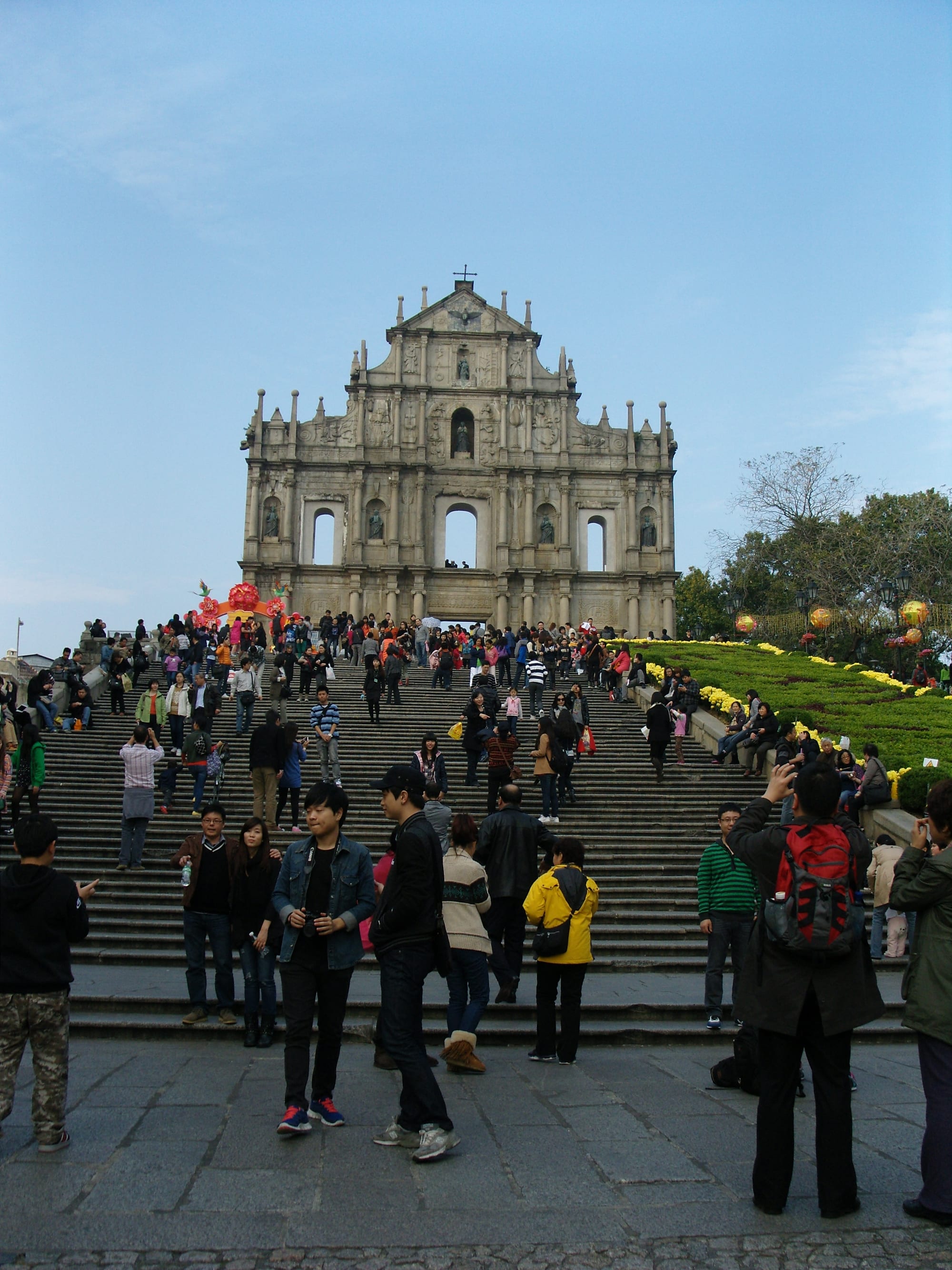A tall carved baroque stone facade at the top of a wide flight of steps