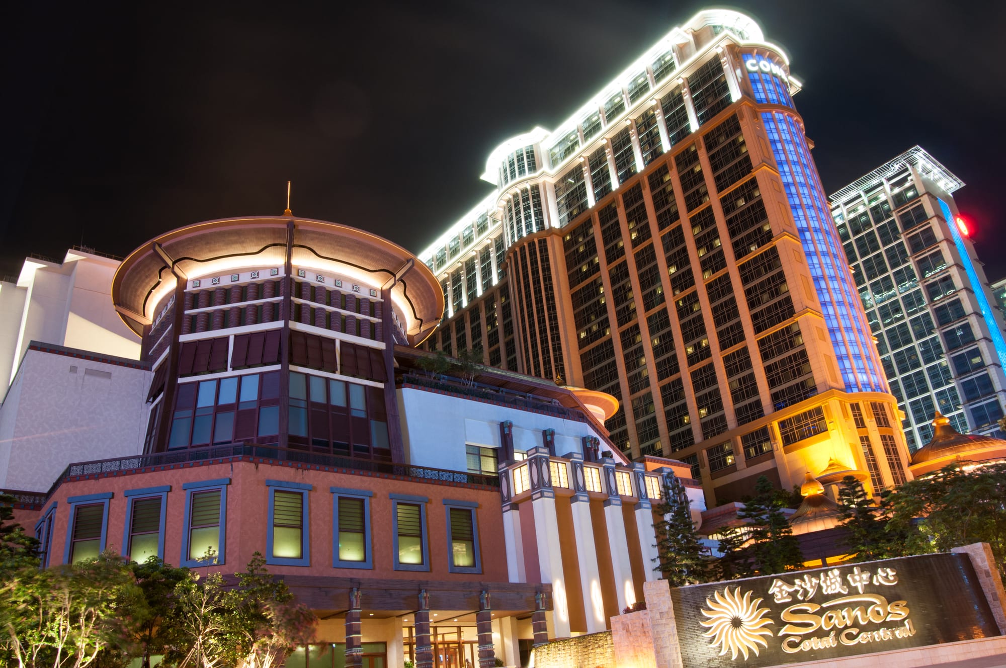 A dense cluster of enormous casino-resort towers on the reclaimed Cotai strip at dusk