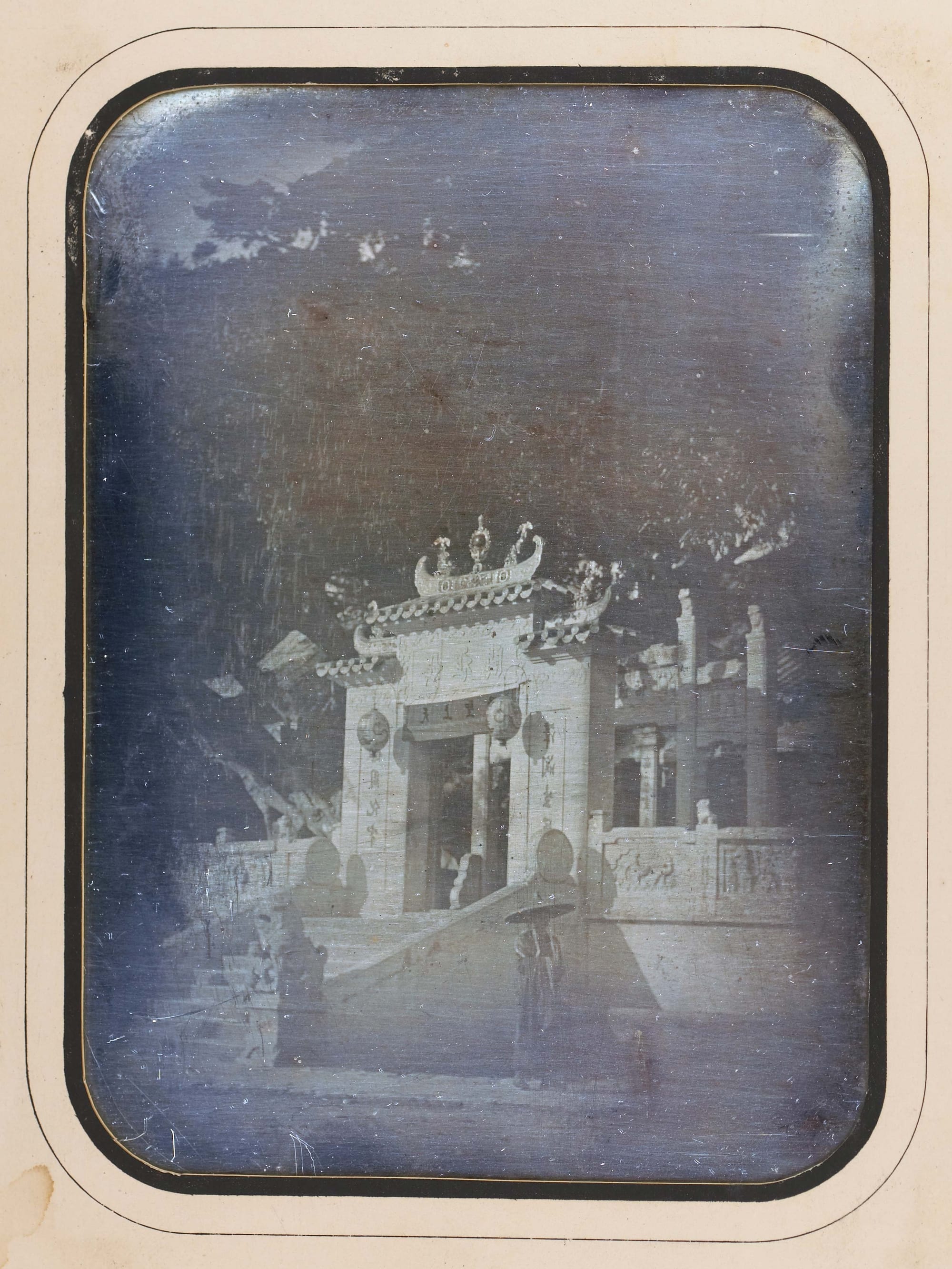 An 1844 photograph of the tiered pavilions of the A-Ma Temple against a rocky hillside