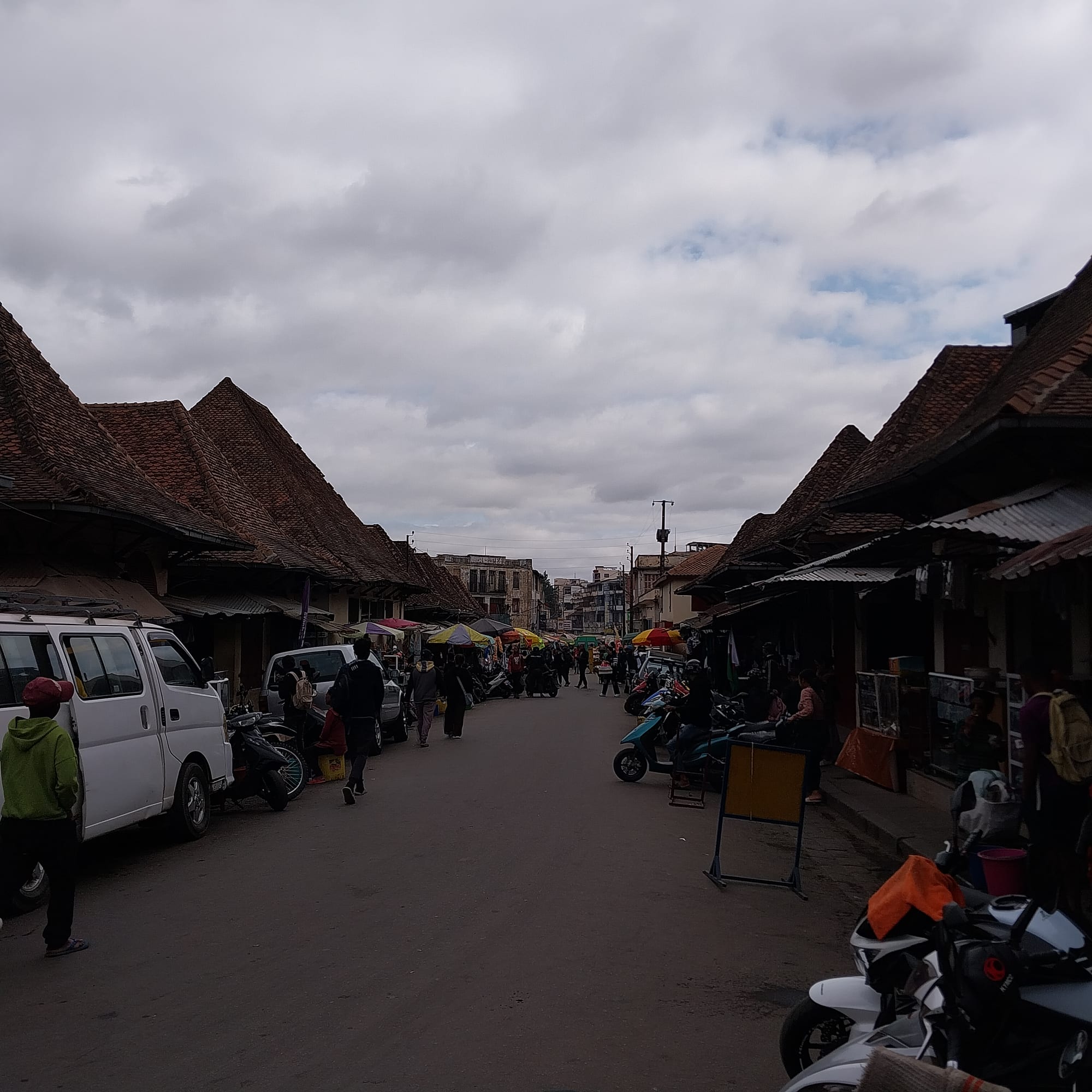 A large open-air market with many stalls and shoppers
