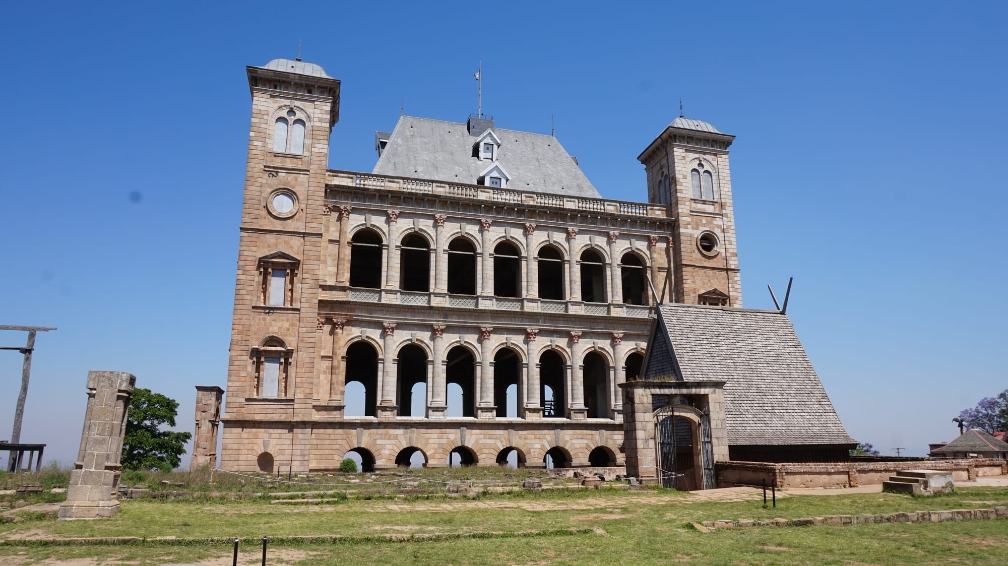 A tall stone royal palace with steep roofs on a hill above Antananarivo