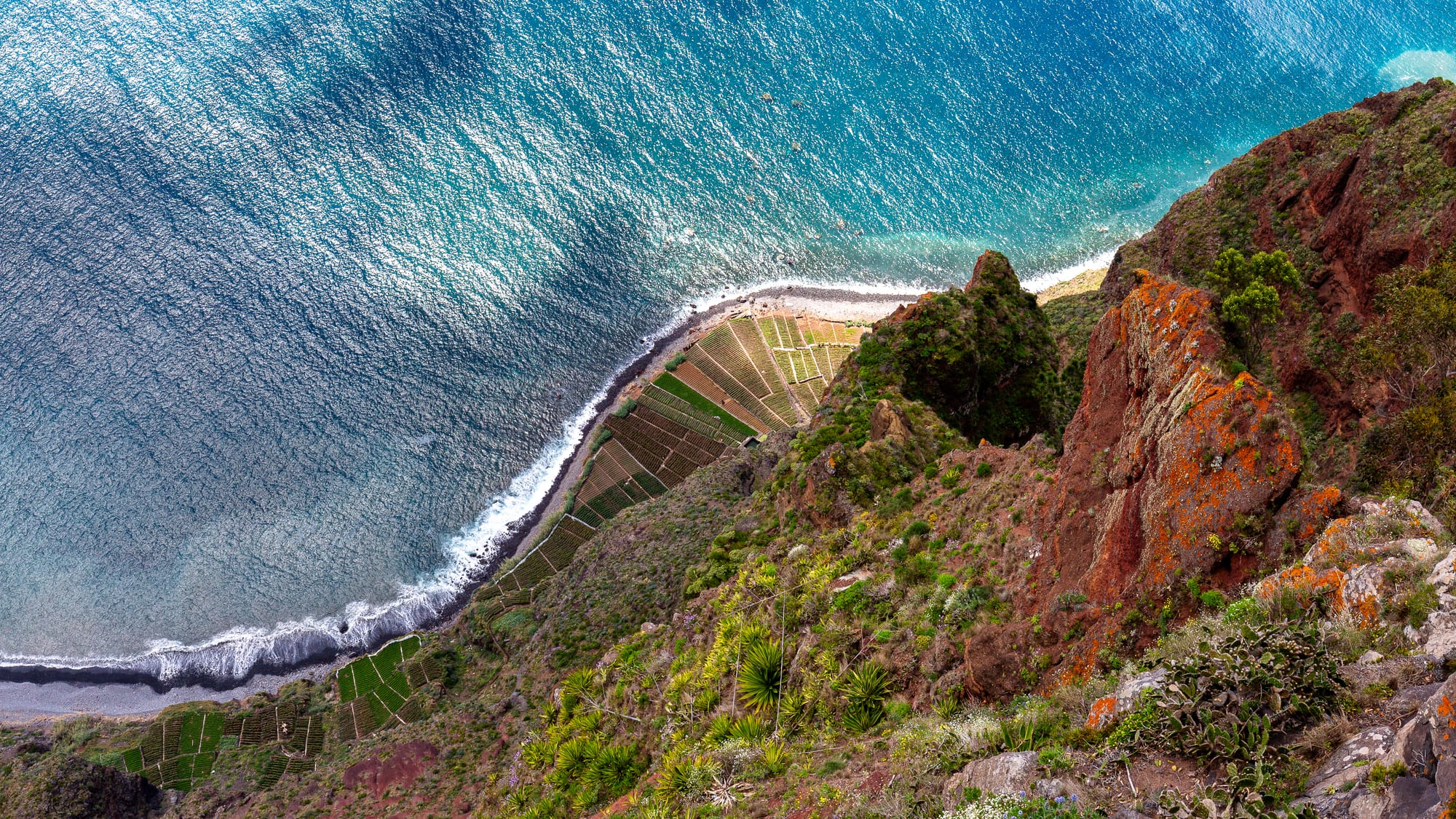 A sheer cliff dropping straight to the sea, with a glass viewing platform jutting out