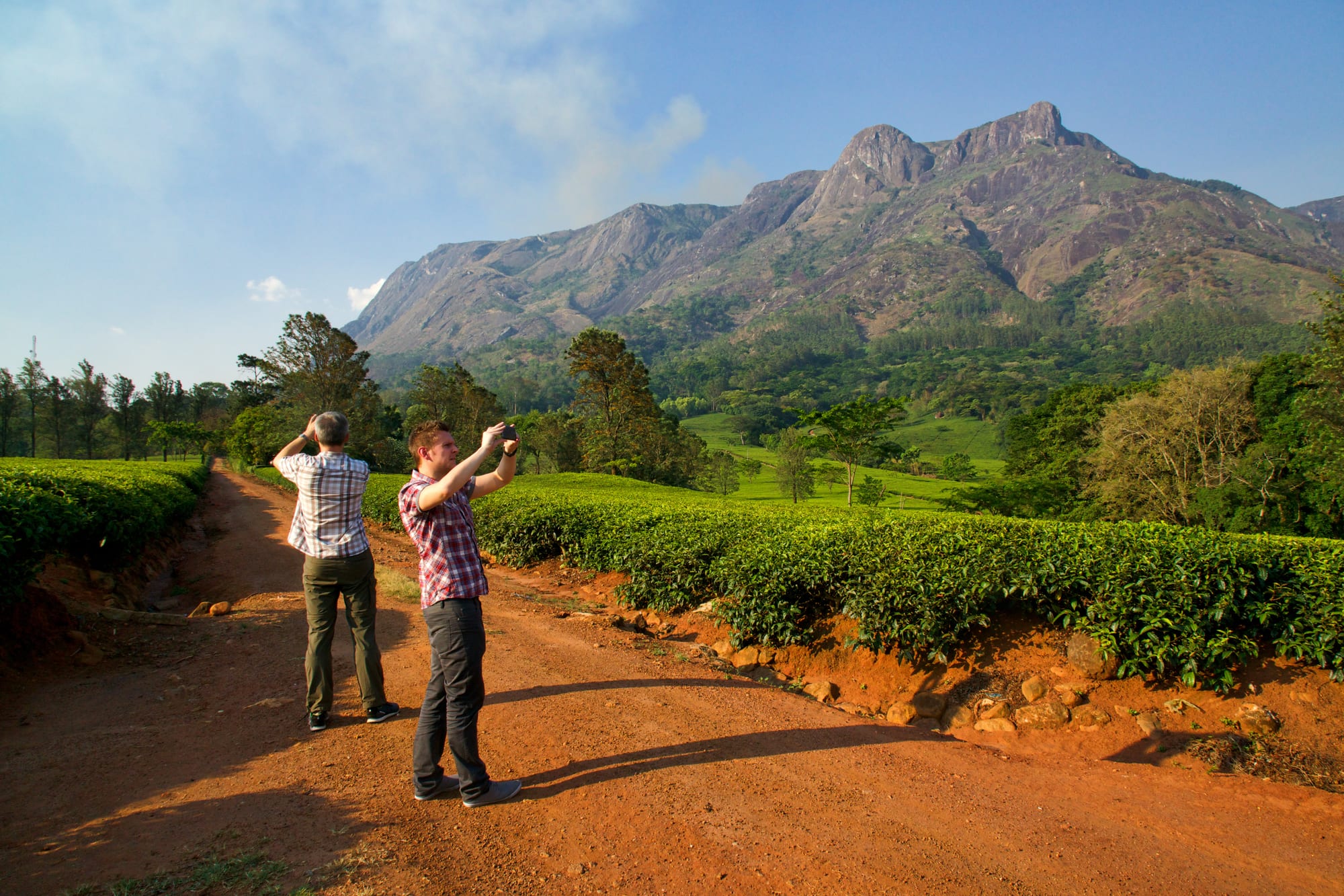 A massive rocky massif rising abruptly from flat green plains