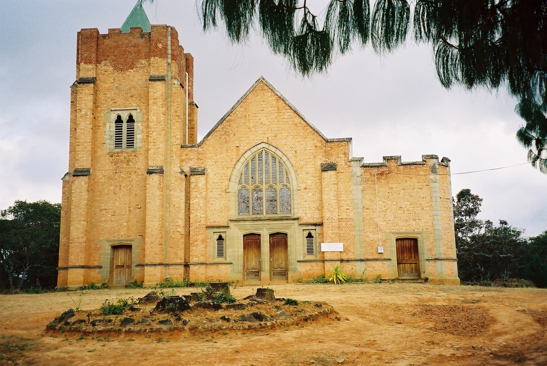 A stone mission church with a square tower on a highland plateau at Livingstonia
