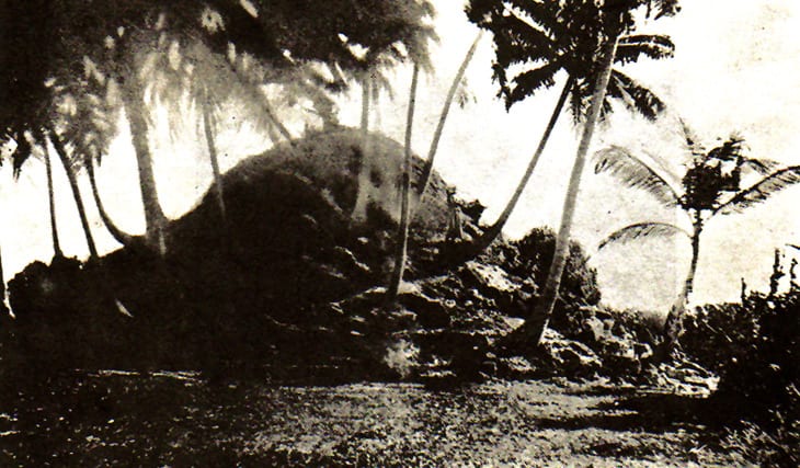 A 1922 photograph of a low overgrown mound, the ruins of a Buddhist stupa on a Maldivian island