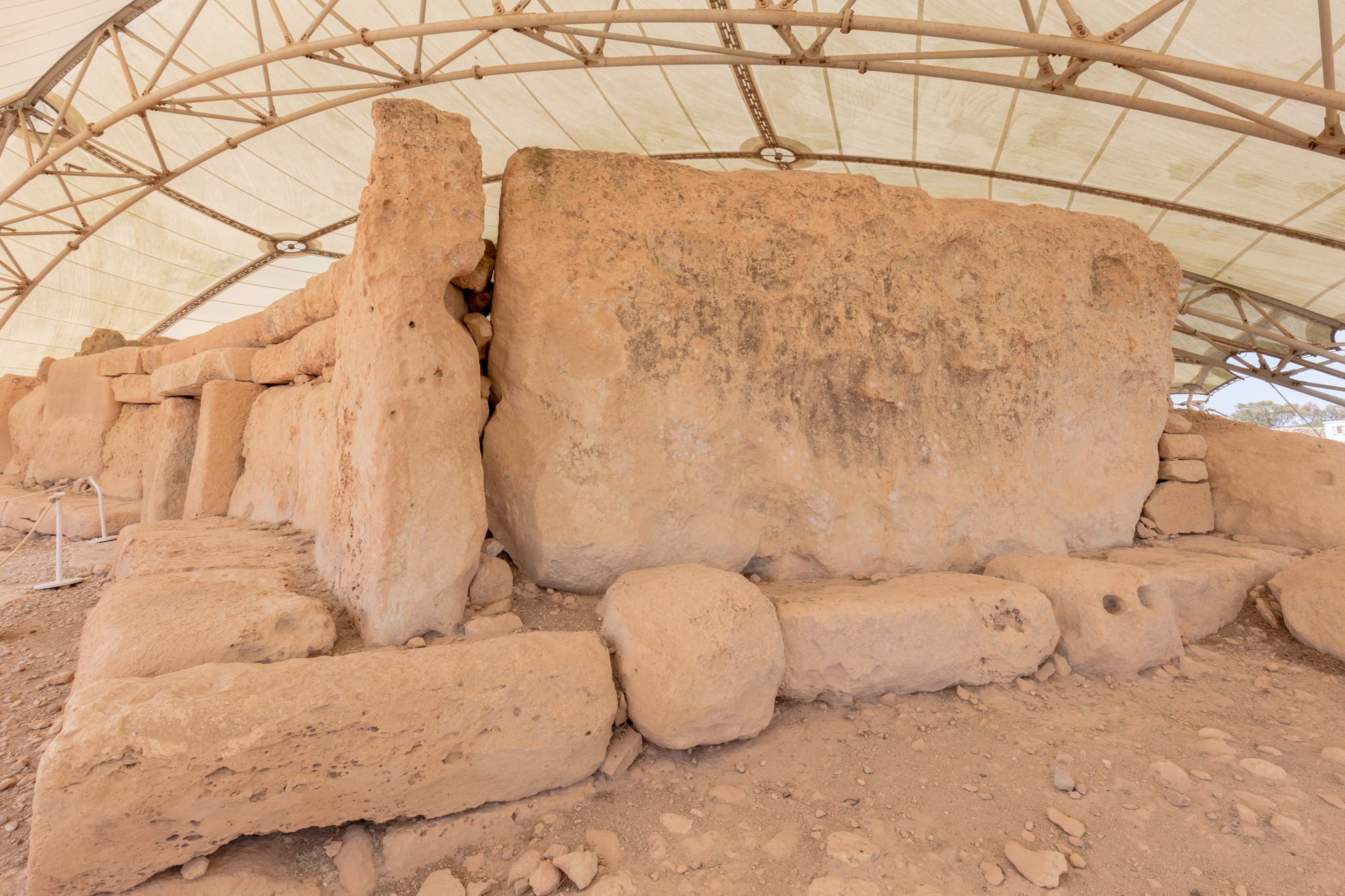 Massive weathered limestone megaliths forming an ancient temple complex on a coastal hillside