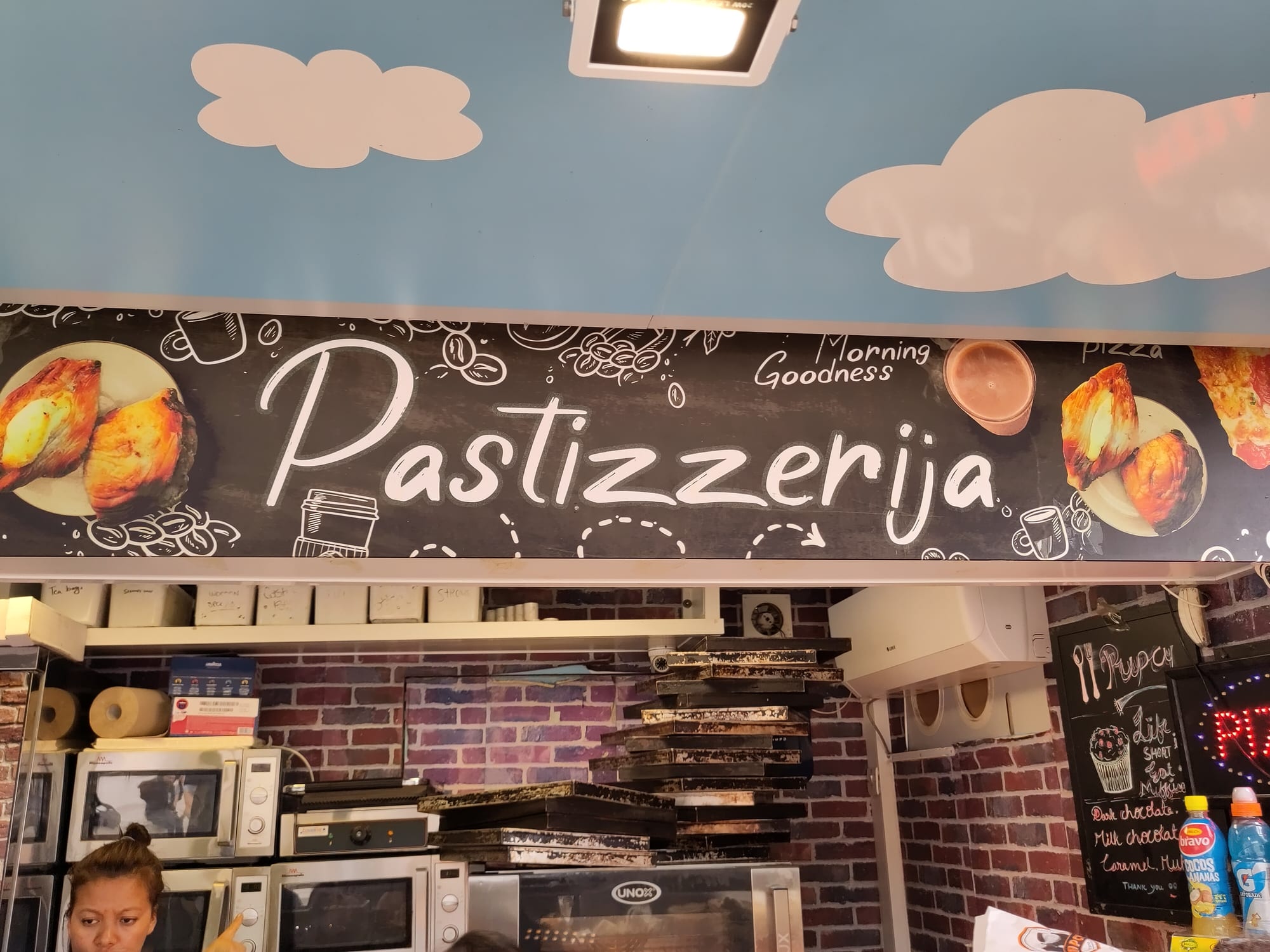 A small pastry shop storefront in a historic street