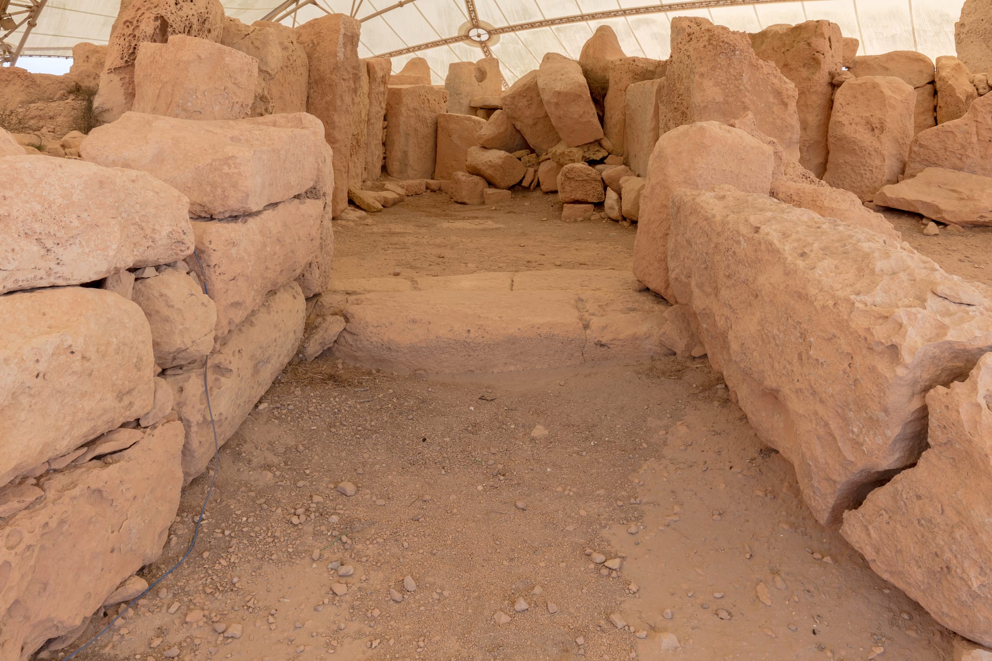 Massive rough-hewn limestone slabs forming the chambers of the Ħaġar Qim temple, on a coastal ridge