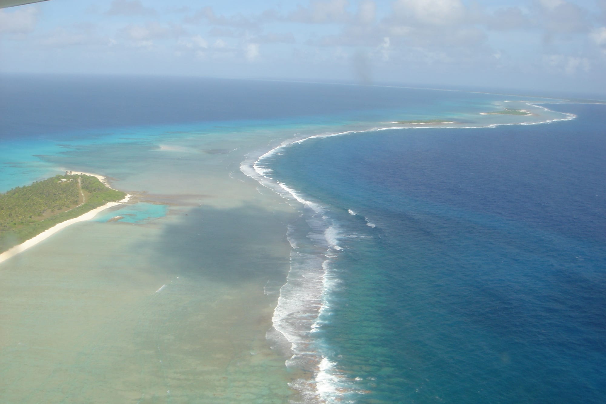 A calm tropical lagoon and low island, the site of historic nuclear weapons tests