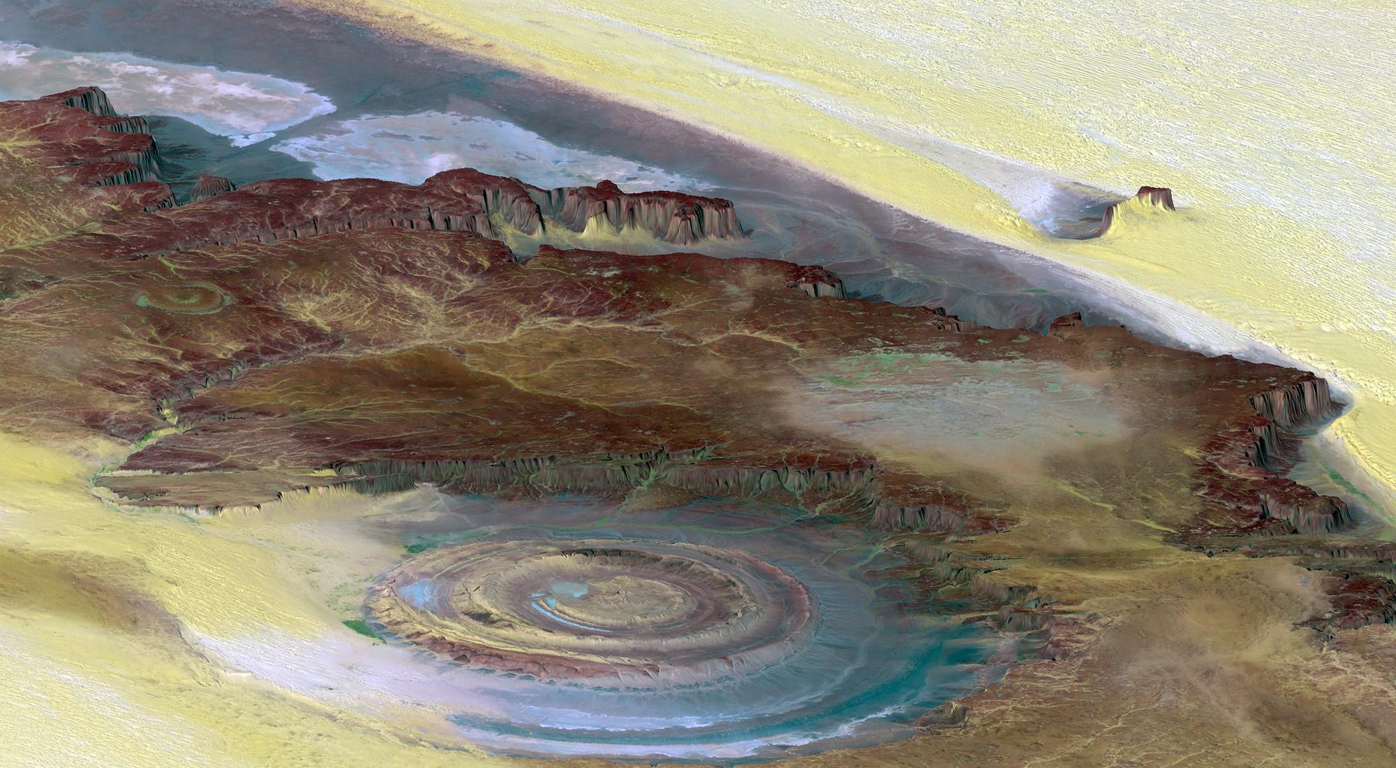 A huge circular bullseye-shaped rock formation visible from orbit in a desert landscape