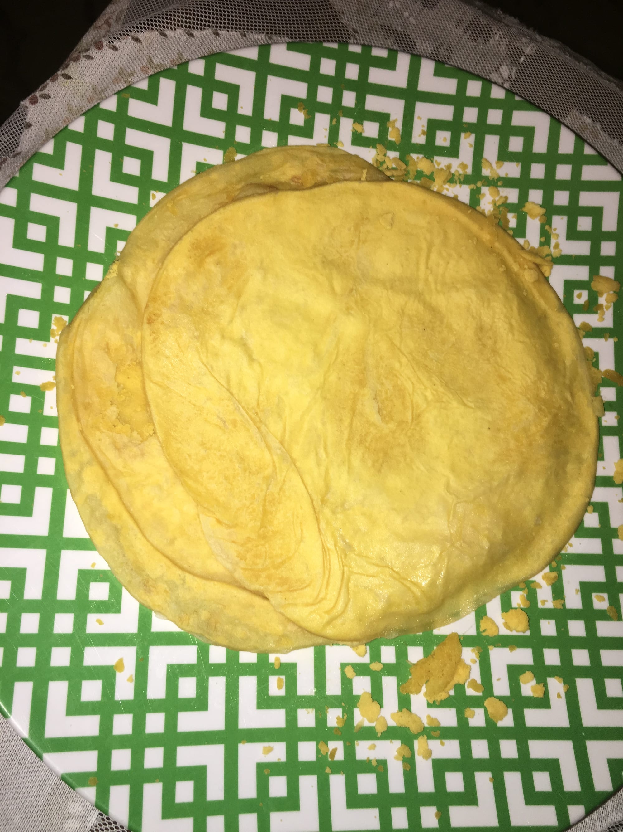 A folded thin flatbread served with curry and chutney