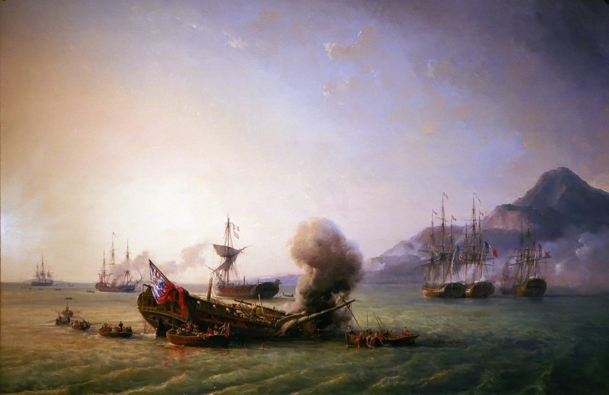An oil painting of sailing warships in a bay beneath a mountainous coast, one dismasted ship pouring smoke while crews pull away in rowing boats