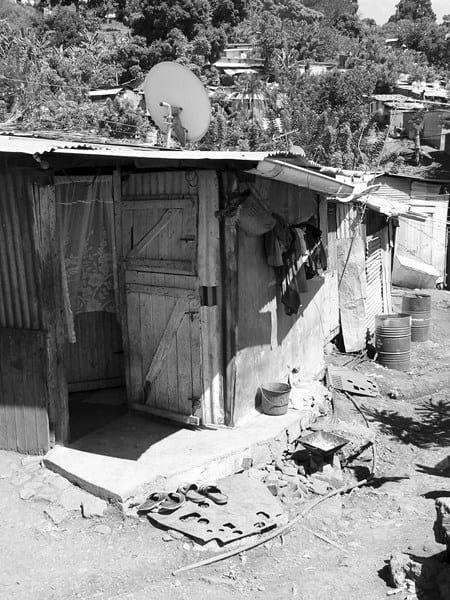 A small self-built house of wood and corrugated metal sheeting in Kawéni, near Mamoudzou, with a satellite dish on the roof
