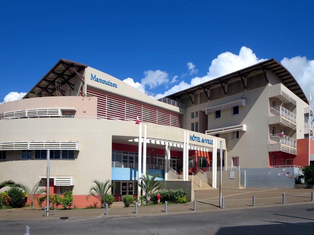 A modern municipal building in a small tropical city centre