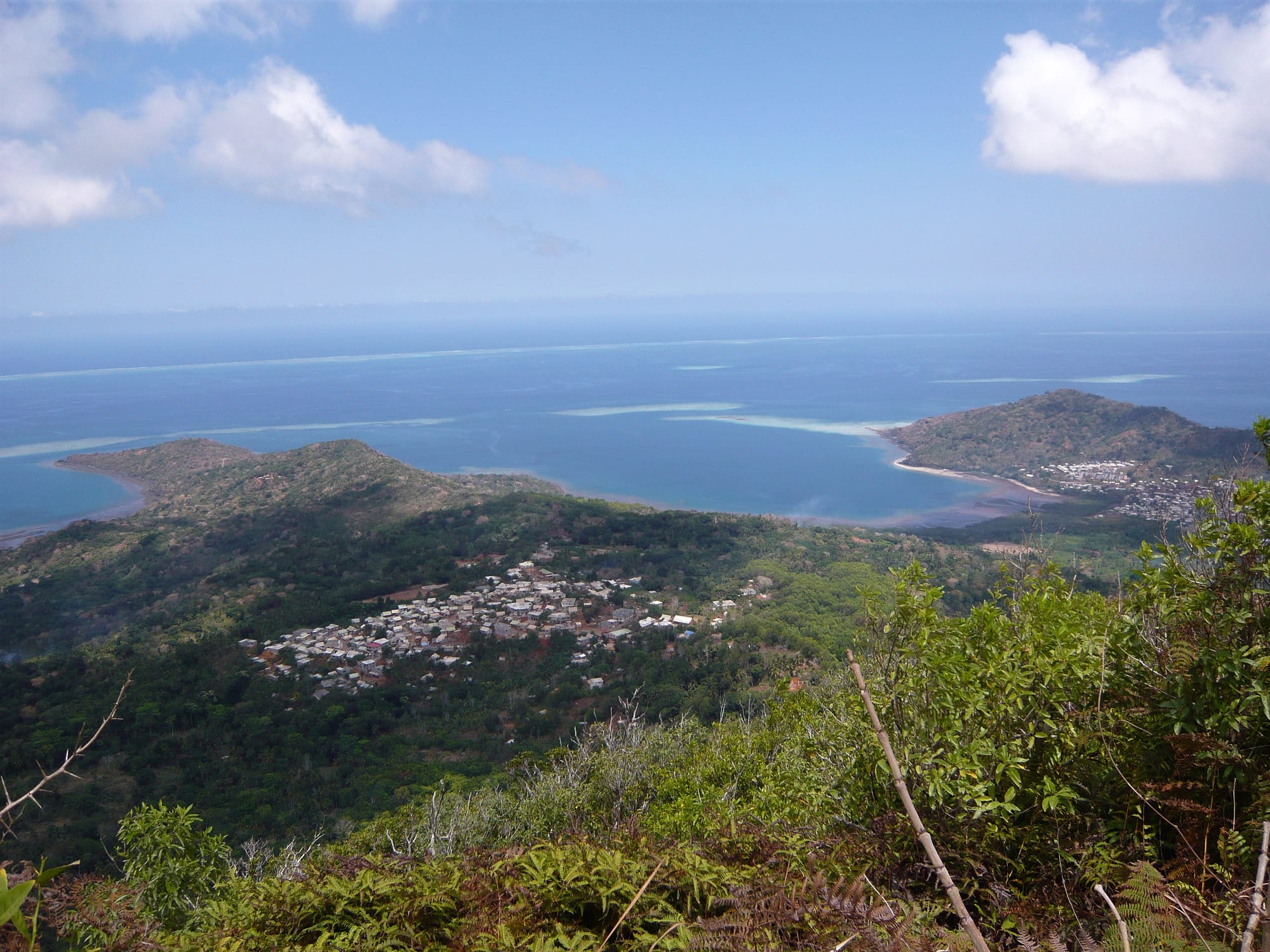 A vast turquoise lagoon enclosed by a distant line of surf breaking on a barrier reef