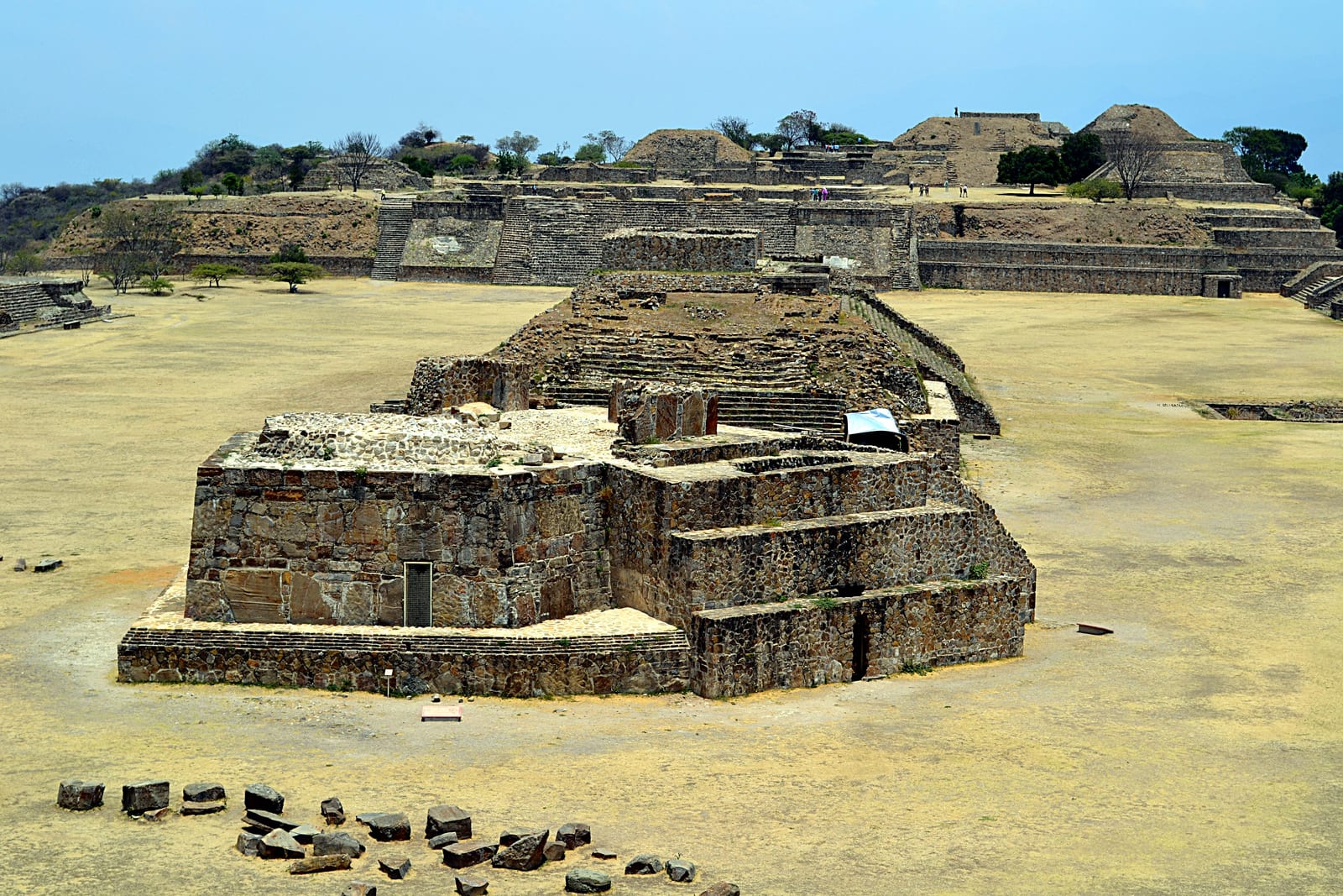 Stone ruins and terraces on a flattened hilltop overlooking a valley