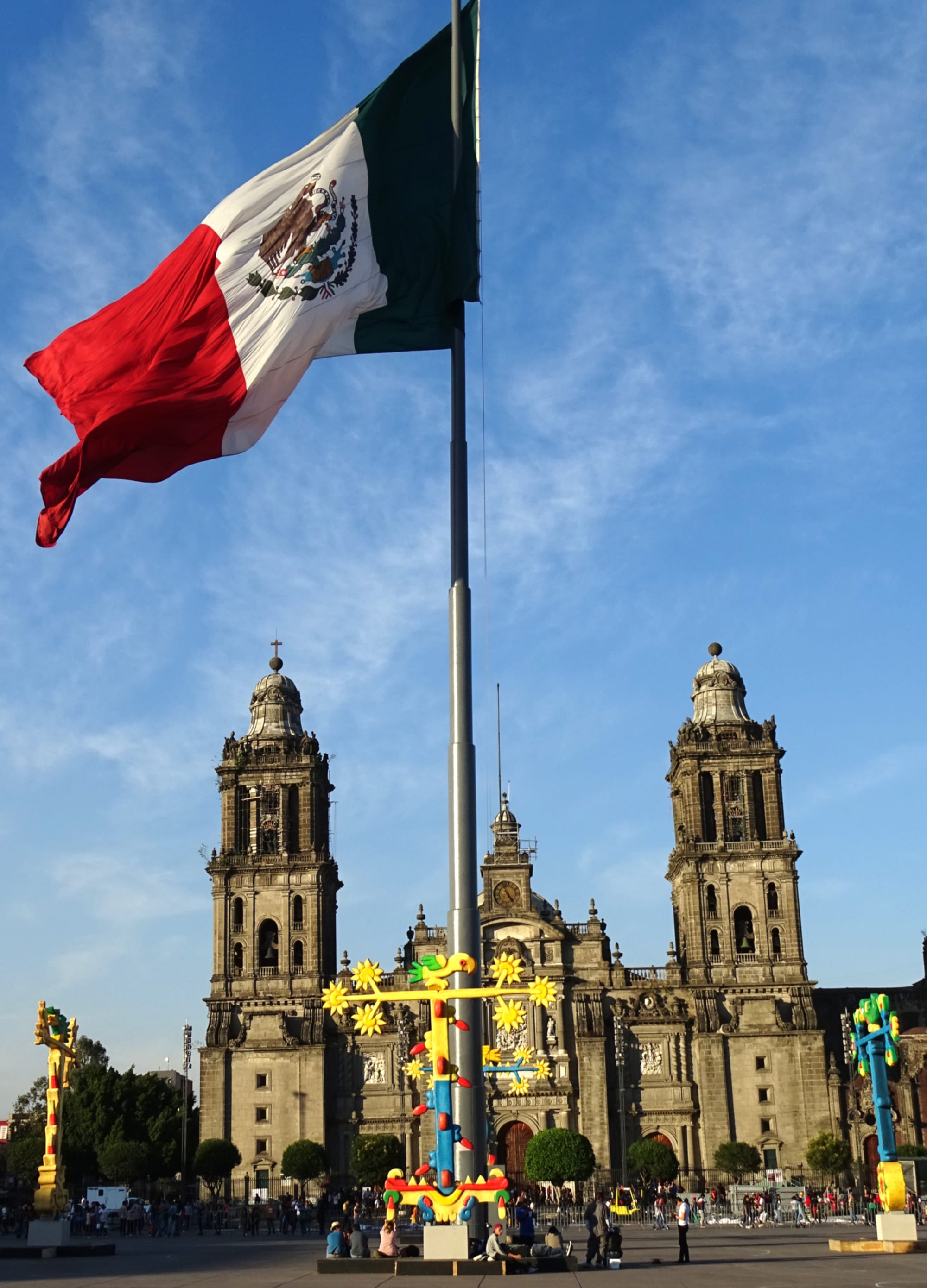 A huge central plaza with a giant flag and a large baroque cathedral