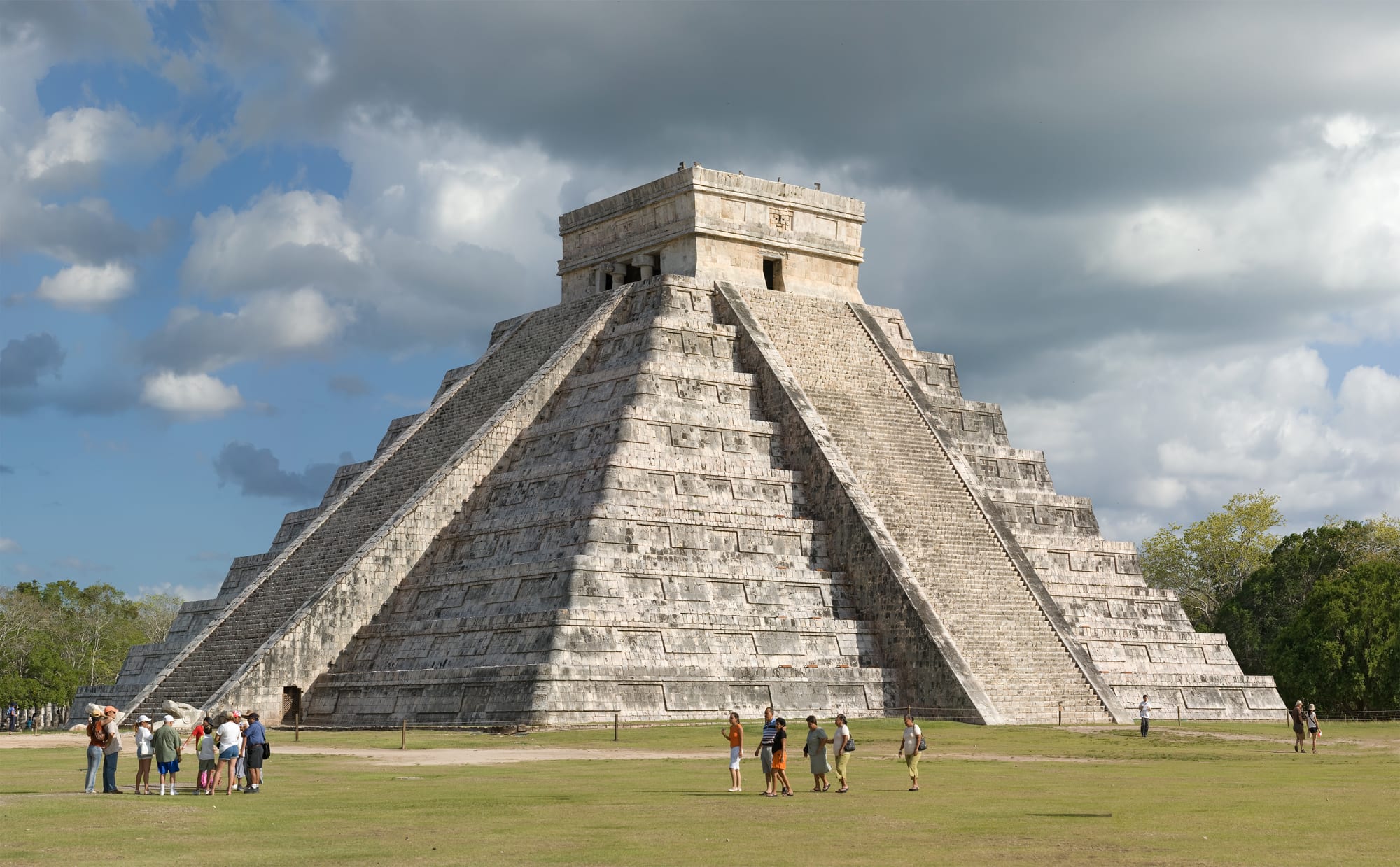 A four-sided stepped pyramid with a temple on top and a staircase on each face
