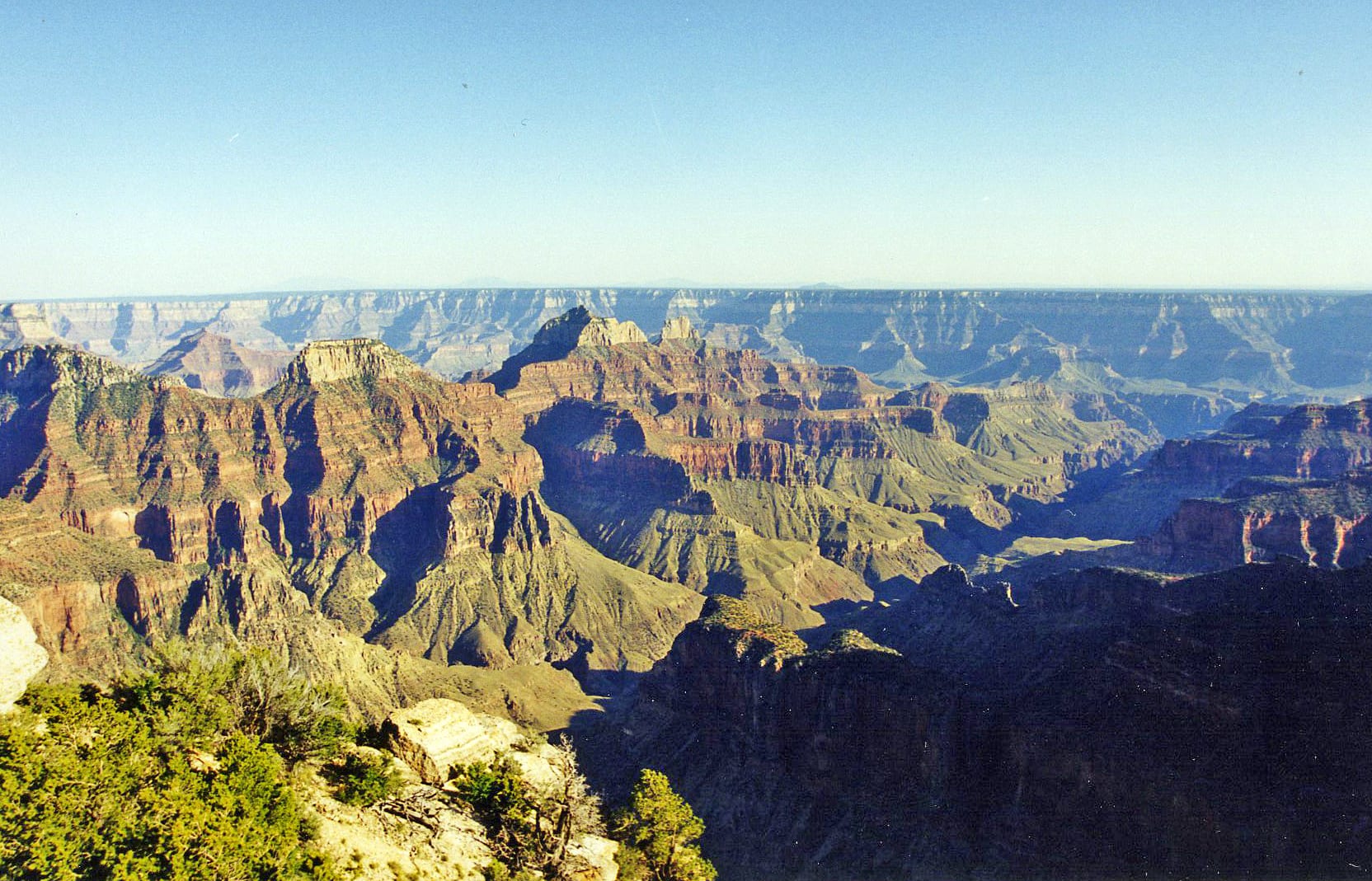 A vast, deep canyon system with layered rock walls stretching to the horizon