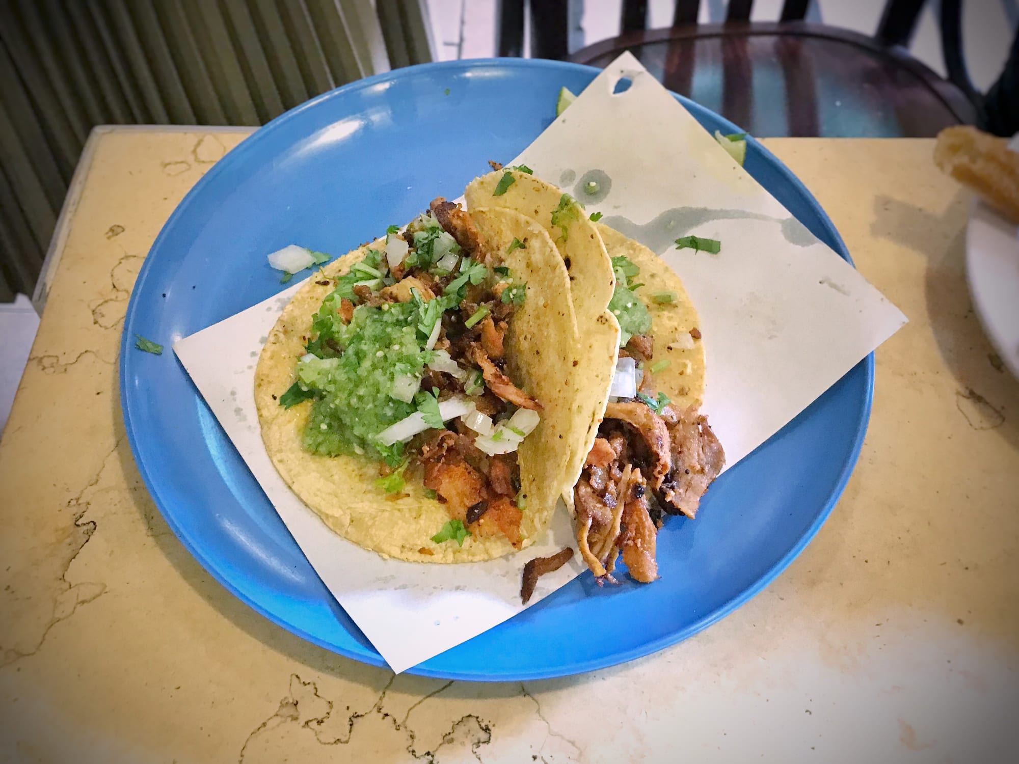 Tacos filled with marinated meat, pineapple and cilantro