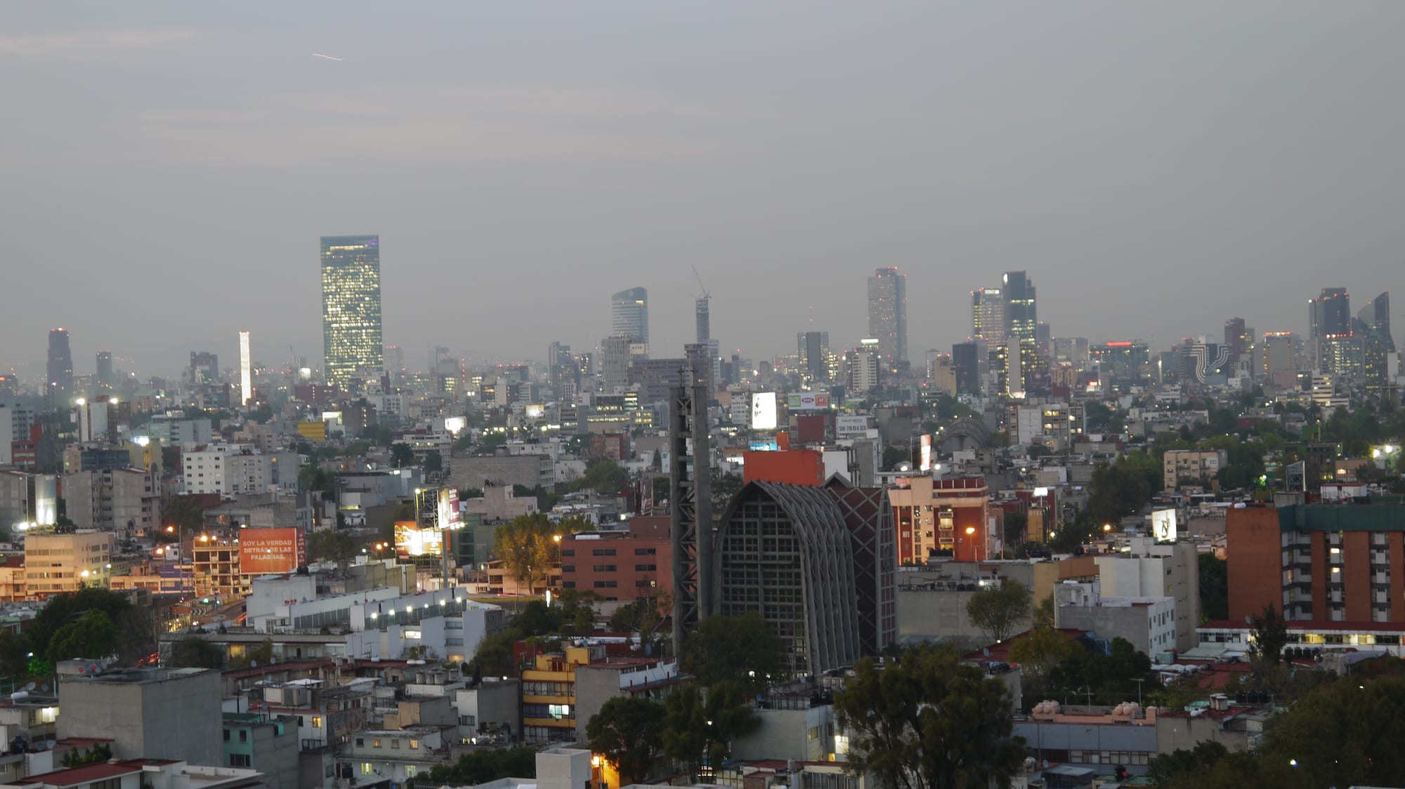 The high-rise skyline along Paseo de la Reforma in Mexico City at dusk