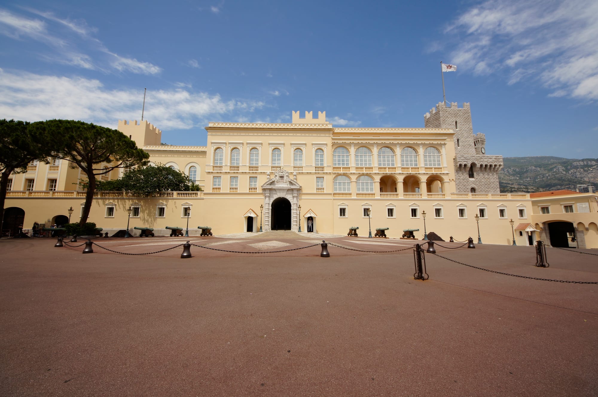 A crenellated Renaissance palace with towers and a broad forecourt on a headland above the sea