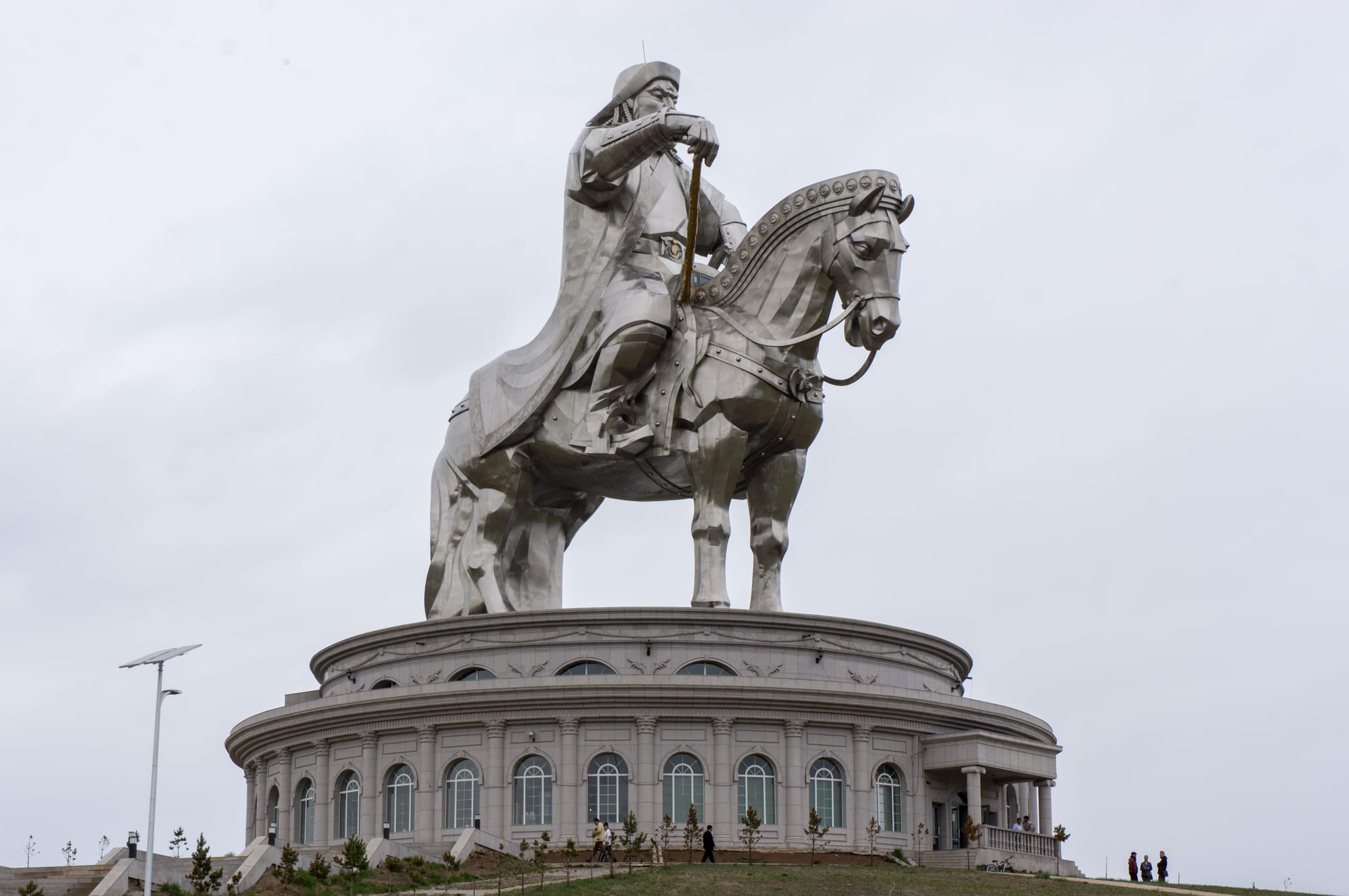 An enormous stainless-steel statue of a mounted warrior on horseback, gleaming in the sun