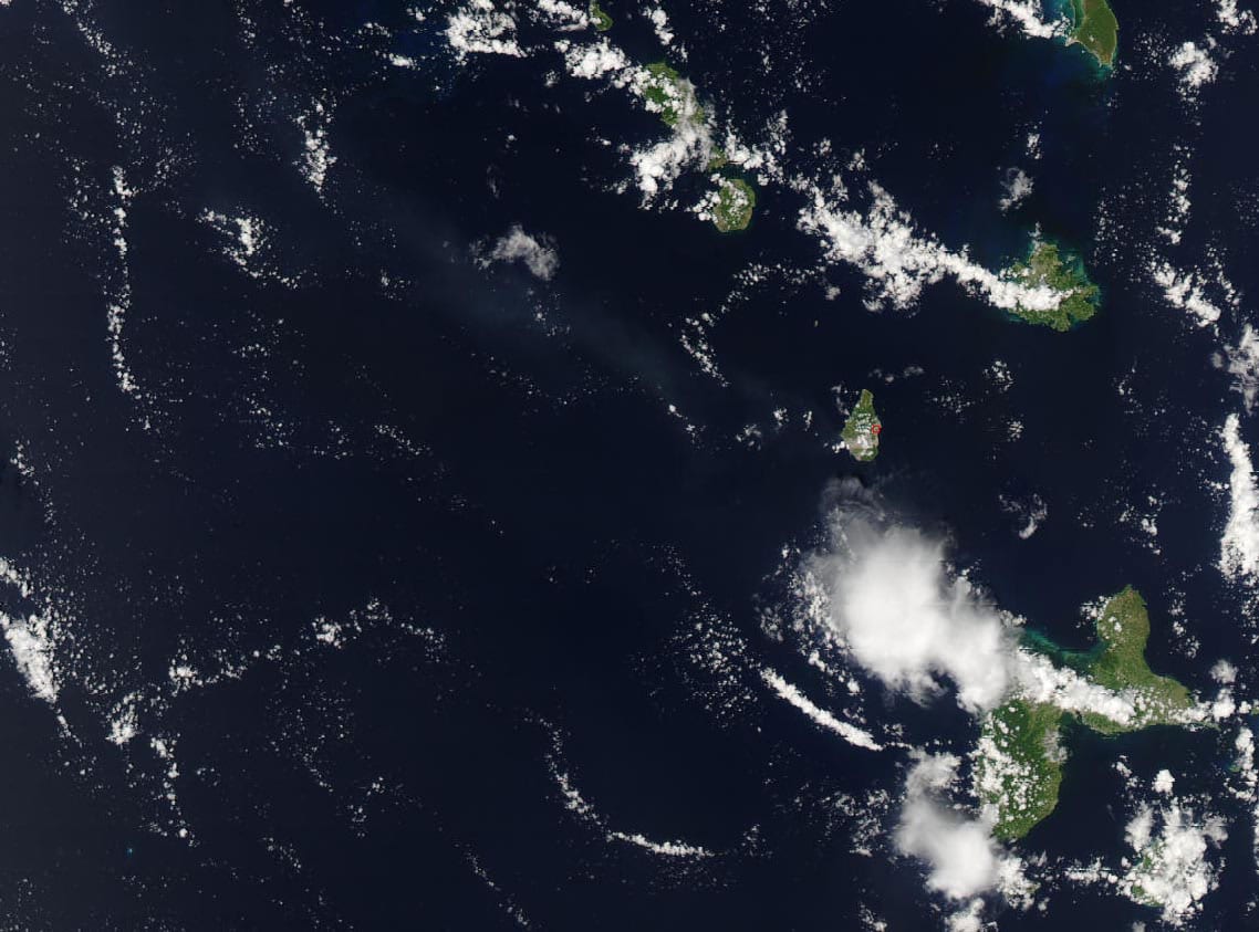 A satellite view of an ash plume streaming from the Soufrière Hills volcano over the sea