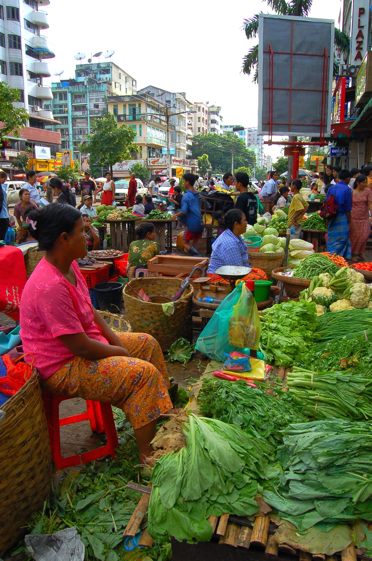 An outdoor market with vendors and produce