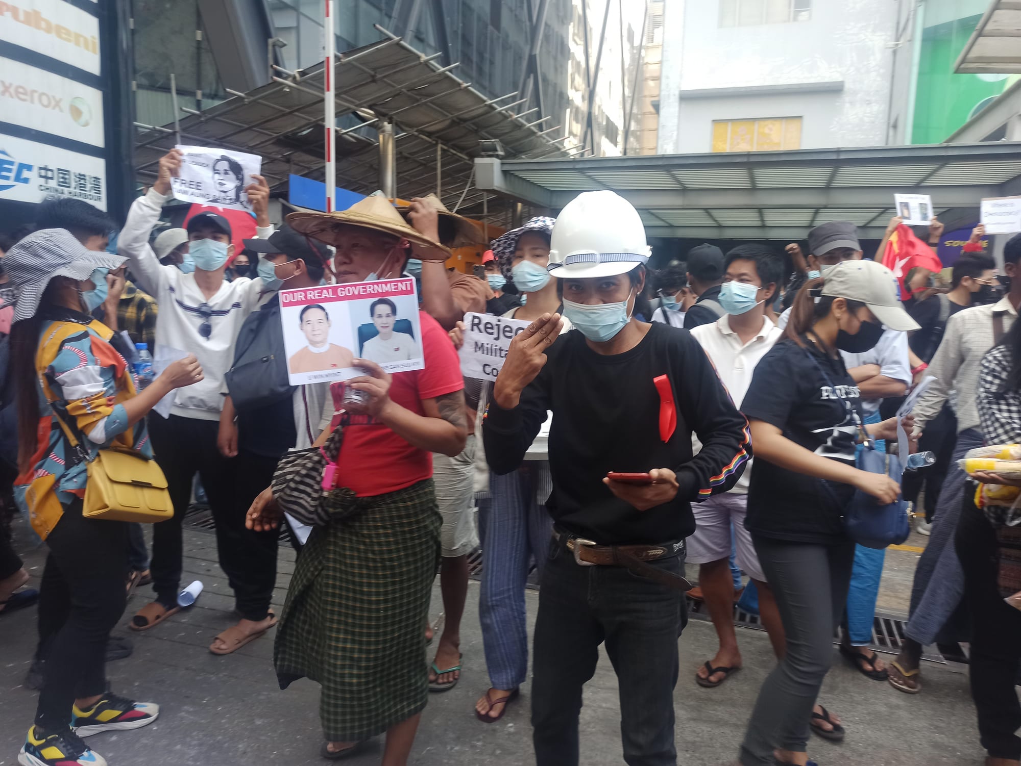 A crowd of protesters in Yangon raising the three-finger salute in February 2021