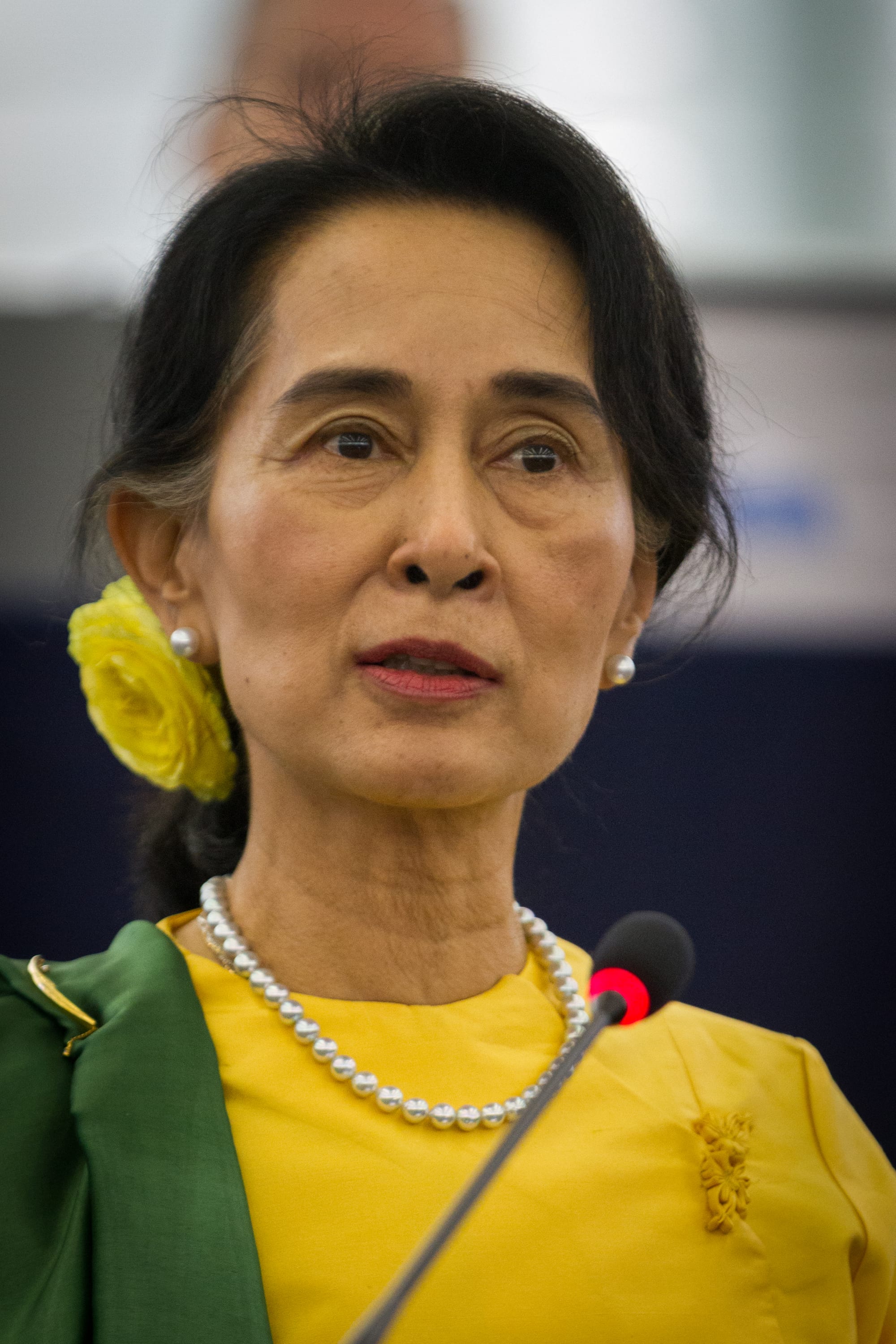 Aung San Suu Kyi speaking at a podium, 2013