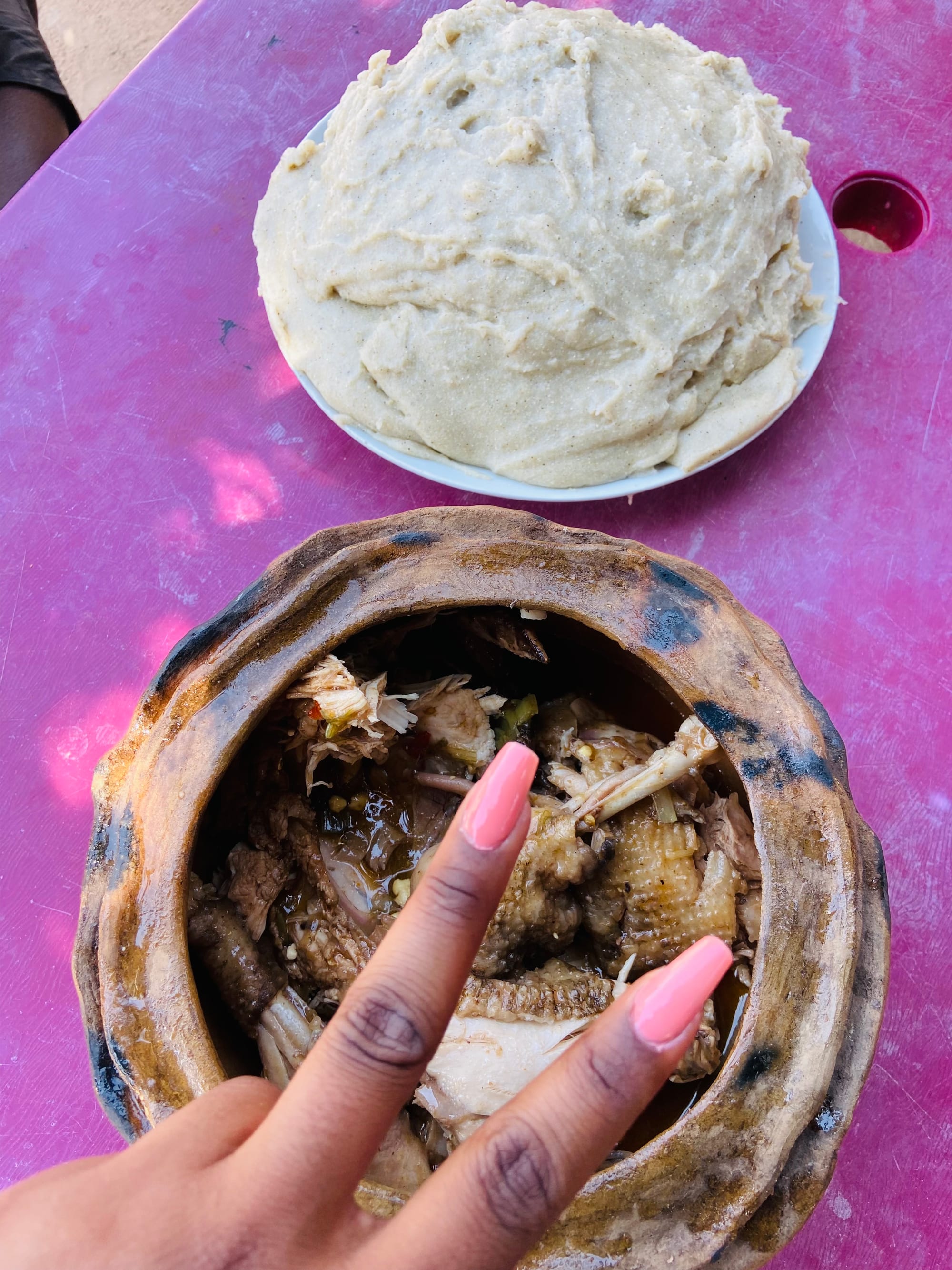 Grilled chicken served with a mound of pale porridge