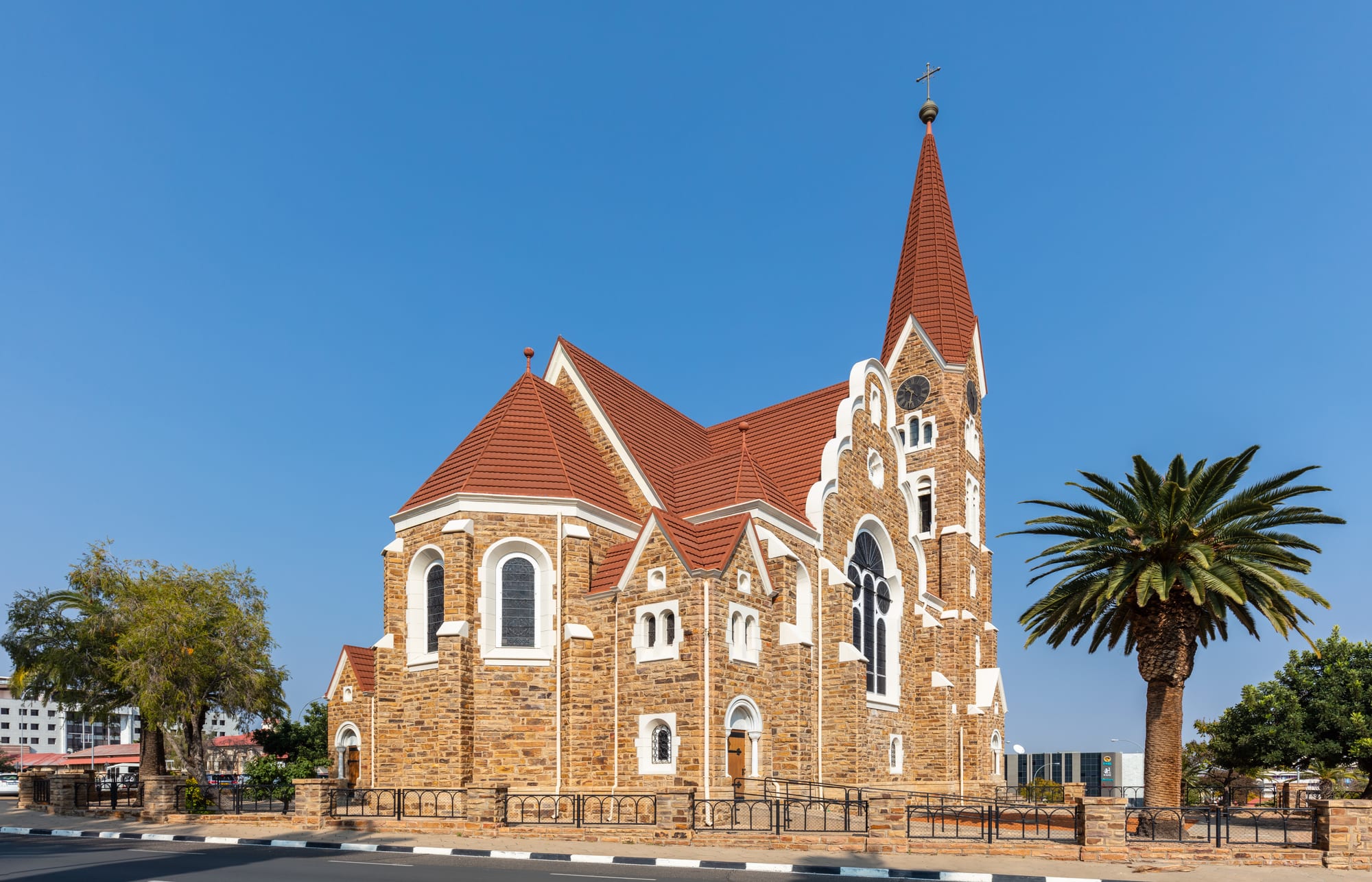 A red sandstone German Lutheran church with a tall spire in central Windhoek