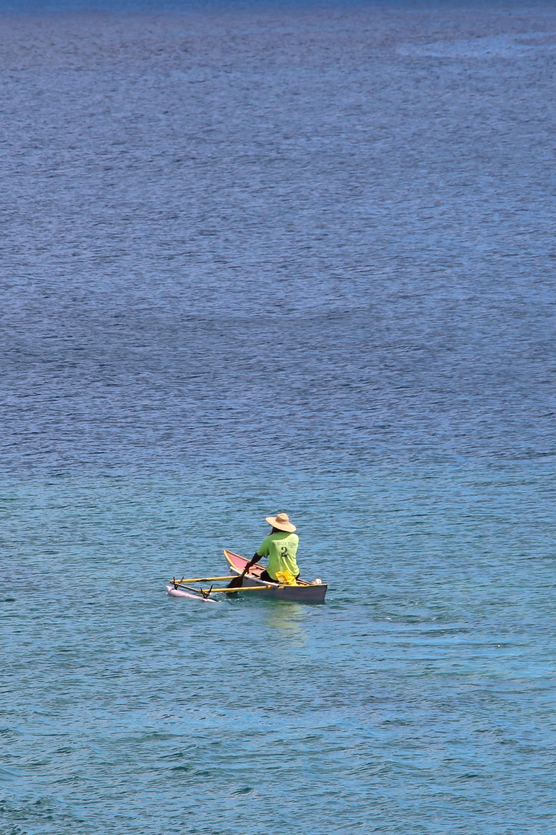 A Nauruan fisherman in a canoe heading out to open ocean