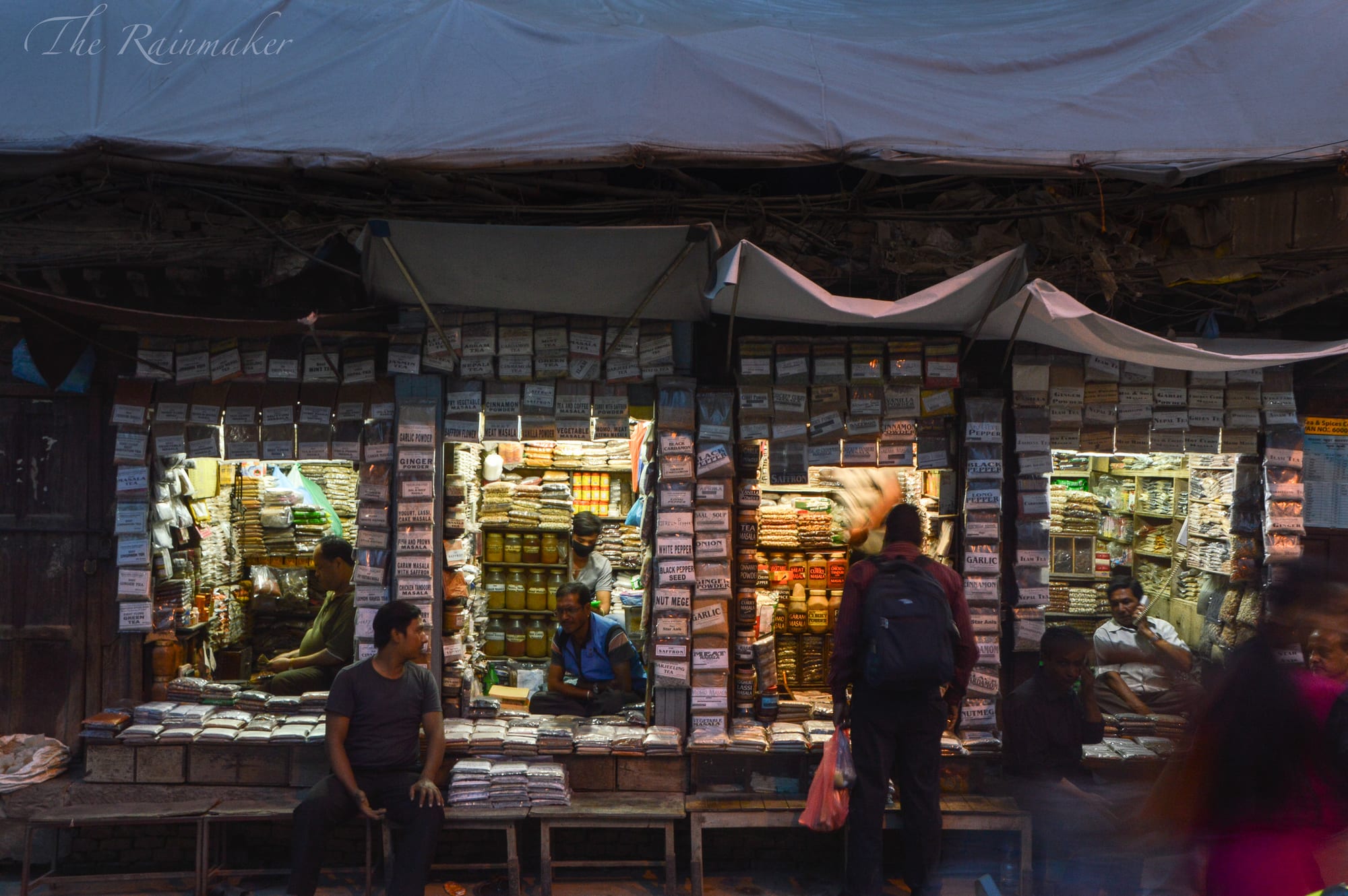 A busy market square with vendors selling spices and goods