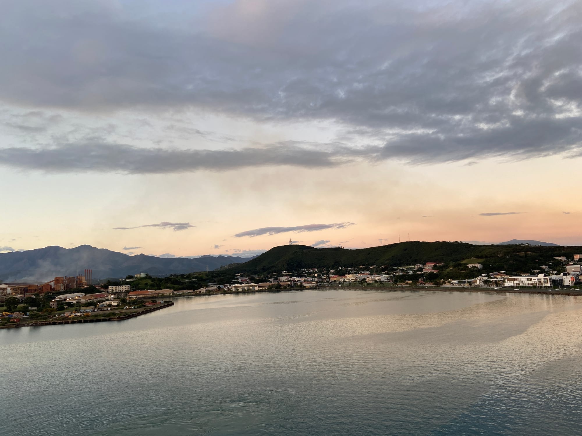 A coastal city with a marina and modern buildings along a bay