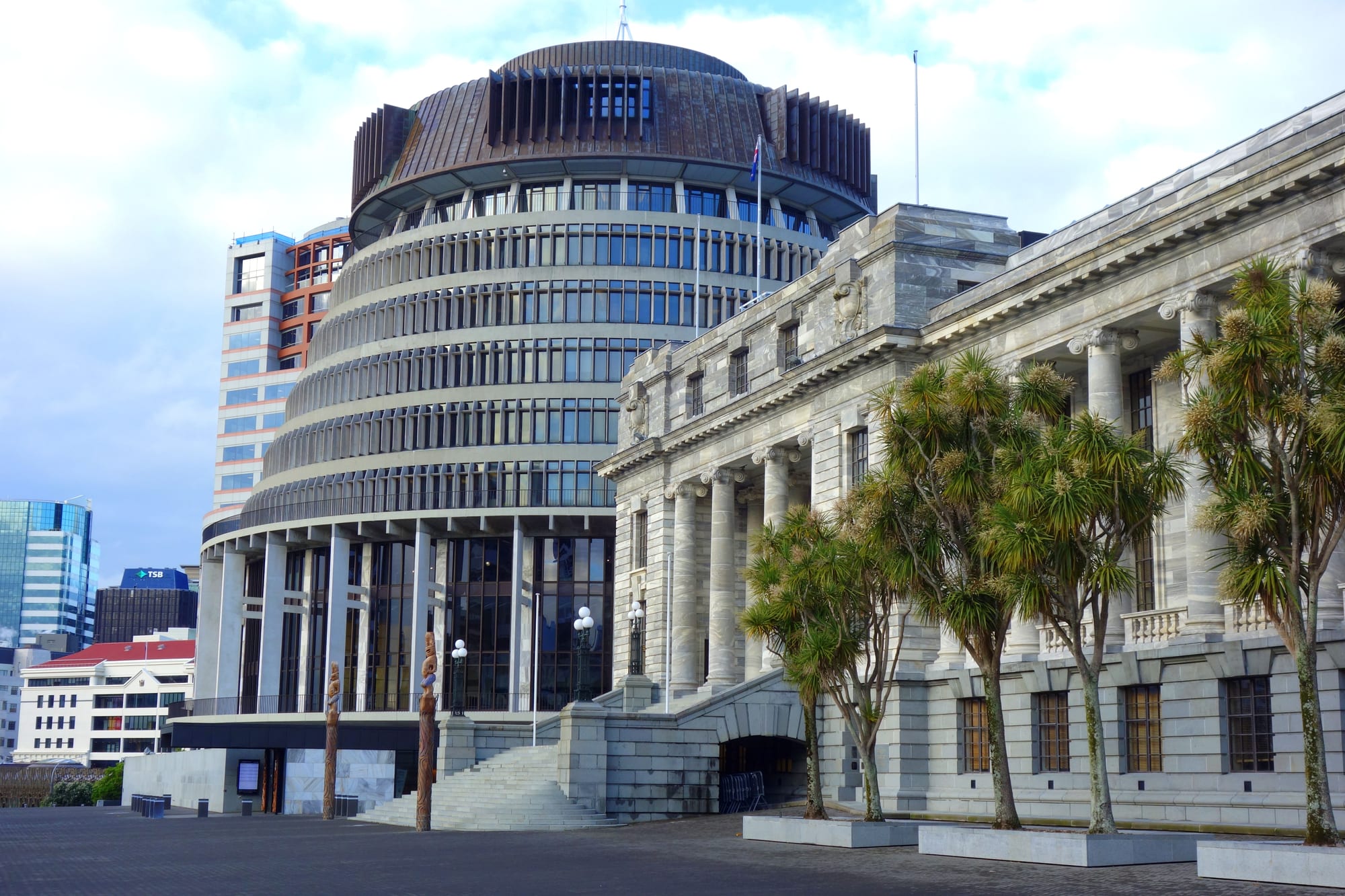 The round, tiered modernist 'Beehive' executive wing beside the older stone Parliament House in Wellington